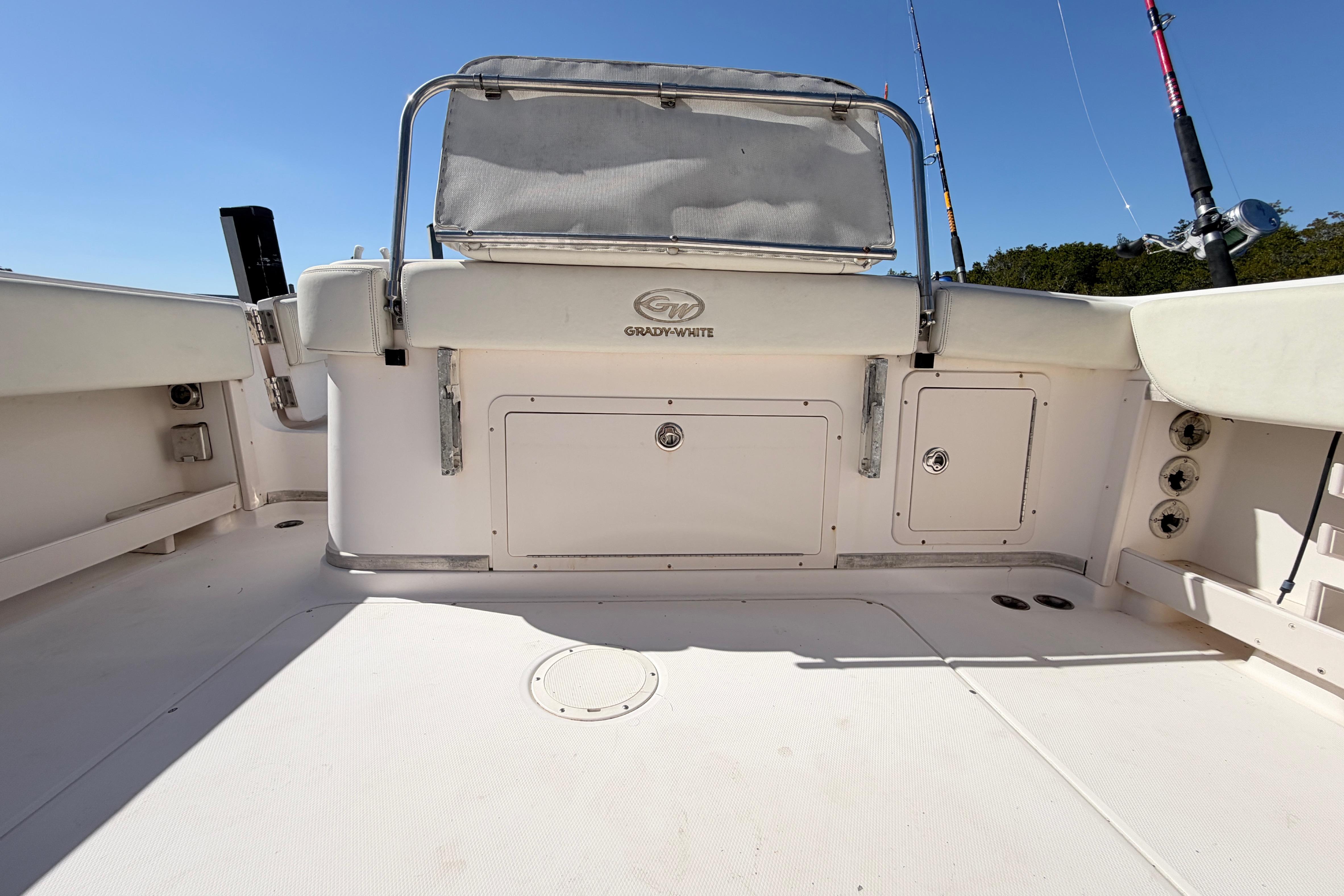 2006 Grady-White Sailfish 282 boat deck with fishing rods and storage compartments.