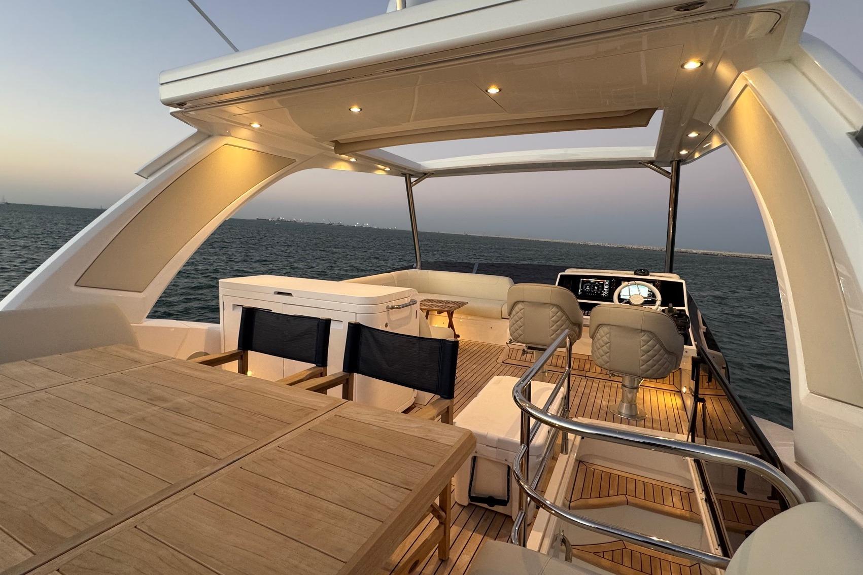 Luxurious 2024 Sunseeker Manhattan 55 yacht interior with elegant seating and ocean view.