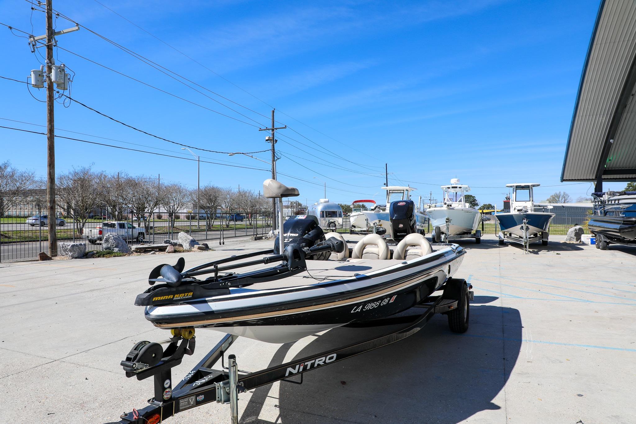2013 Nitro Z-7 boat on trailer in outdoor lot under clear blue sky.