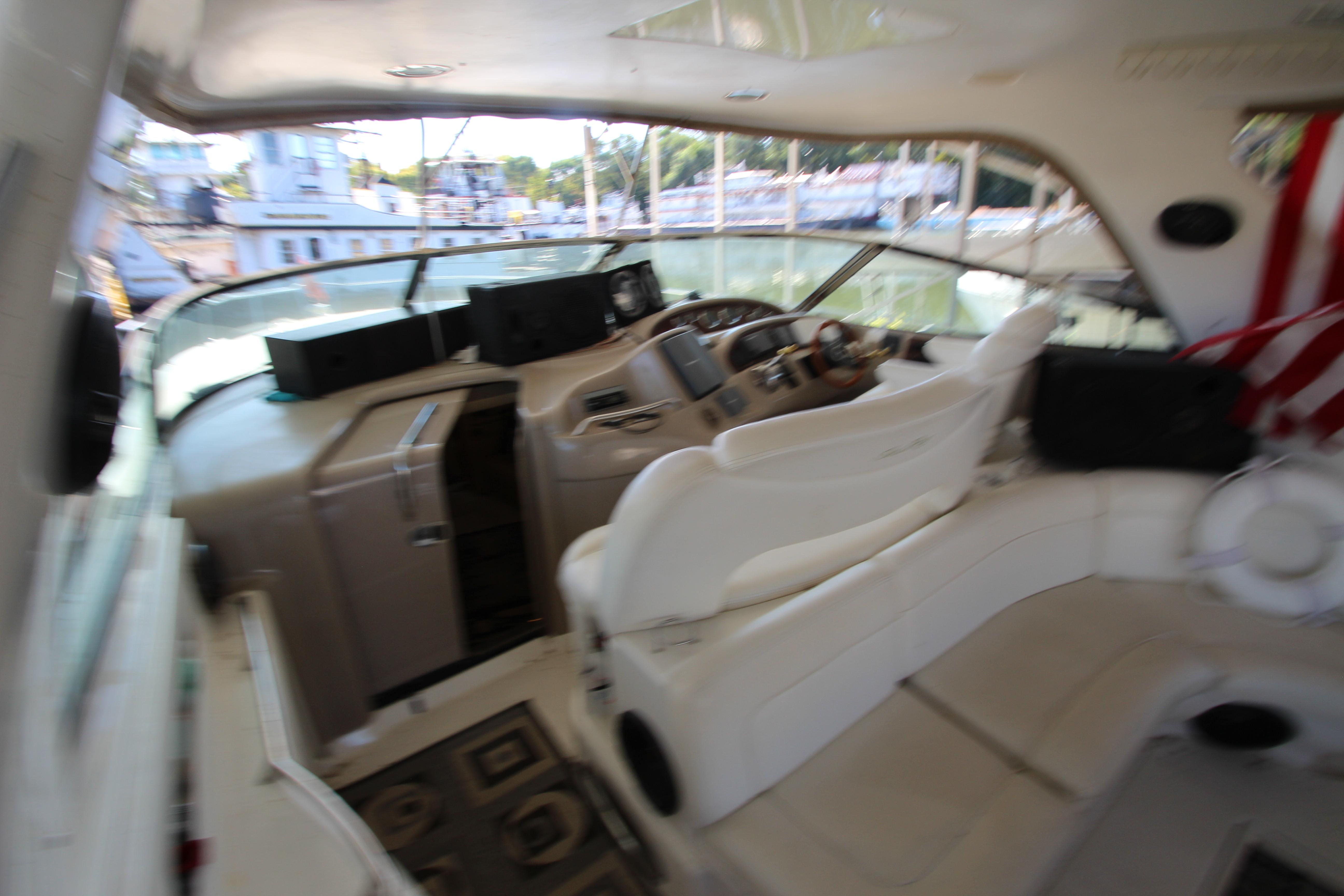 Interior of 2001 Sea Ray 460 Sundancer yacht with helm and seating area.