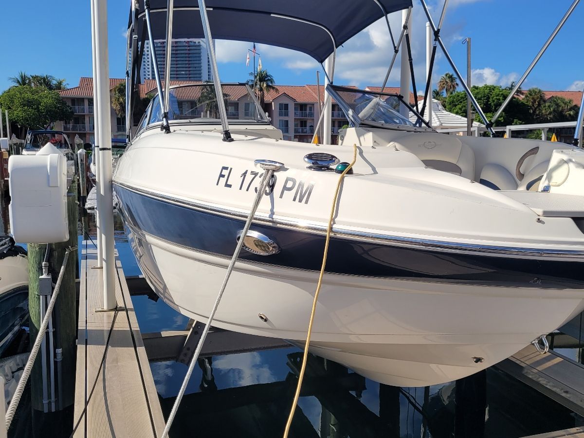 A 2013 Stingray 234 LR boat docked at a marina.