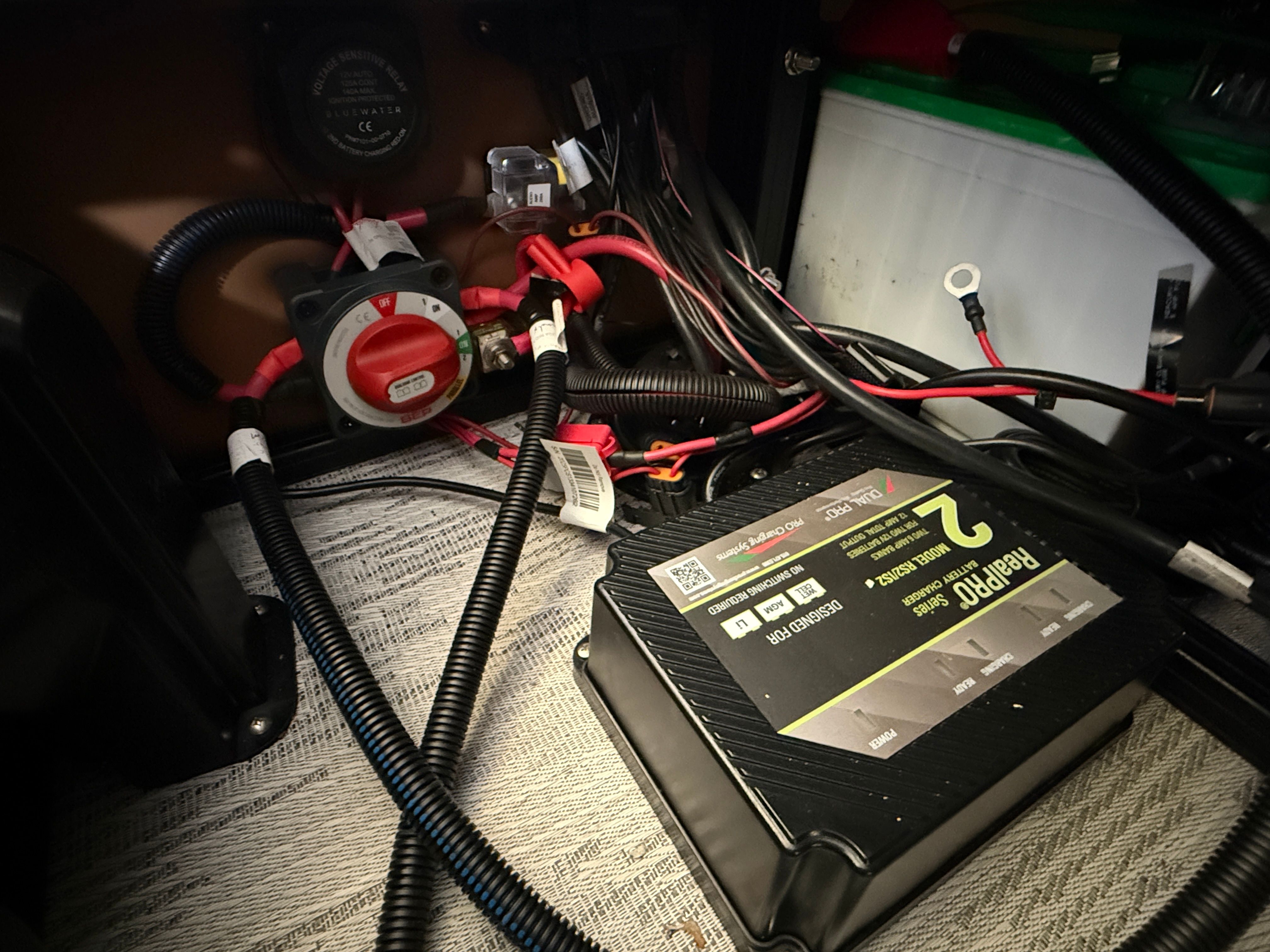 Electrical wiring and components inside a boat, including a battery disconnect switch.