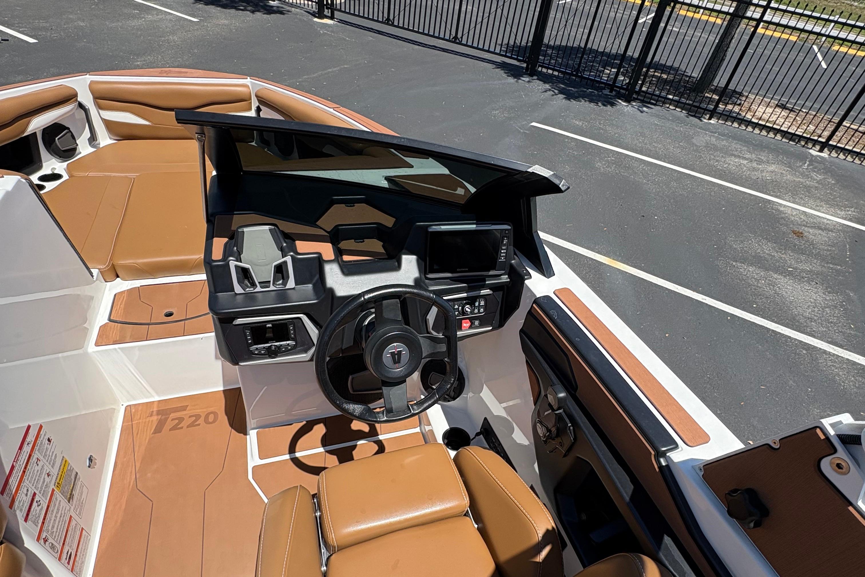 2025 Axis T220 boat interior with tan seating and modern dashboard controls.