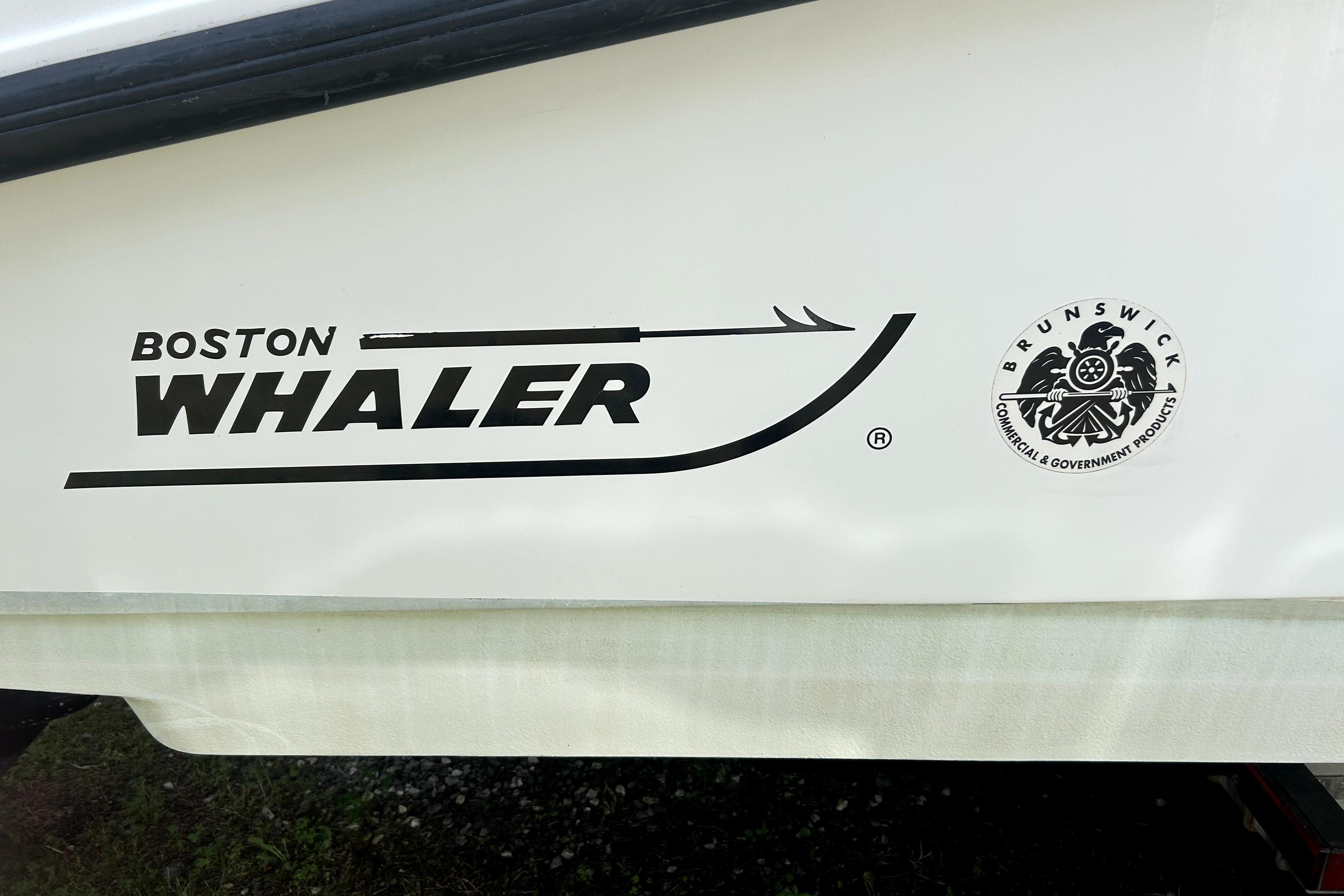 2012 Boston Whaler 320 Outrage logo and Brunswick emblem on boat hull.