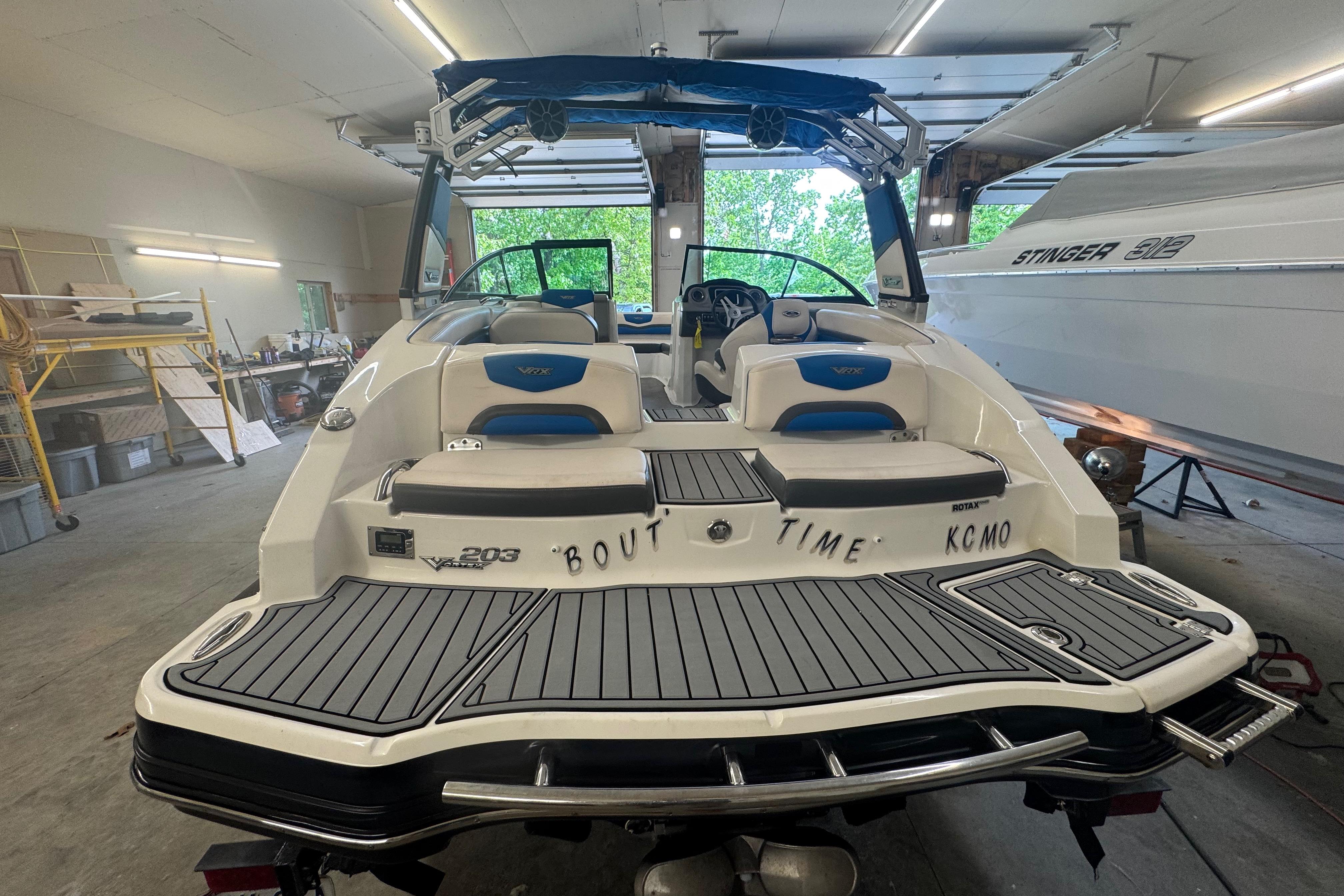 2017 Chaparral Vortex 203 VRX boat in garage, rear view with seating and deck.