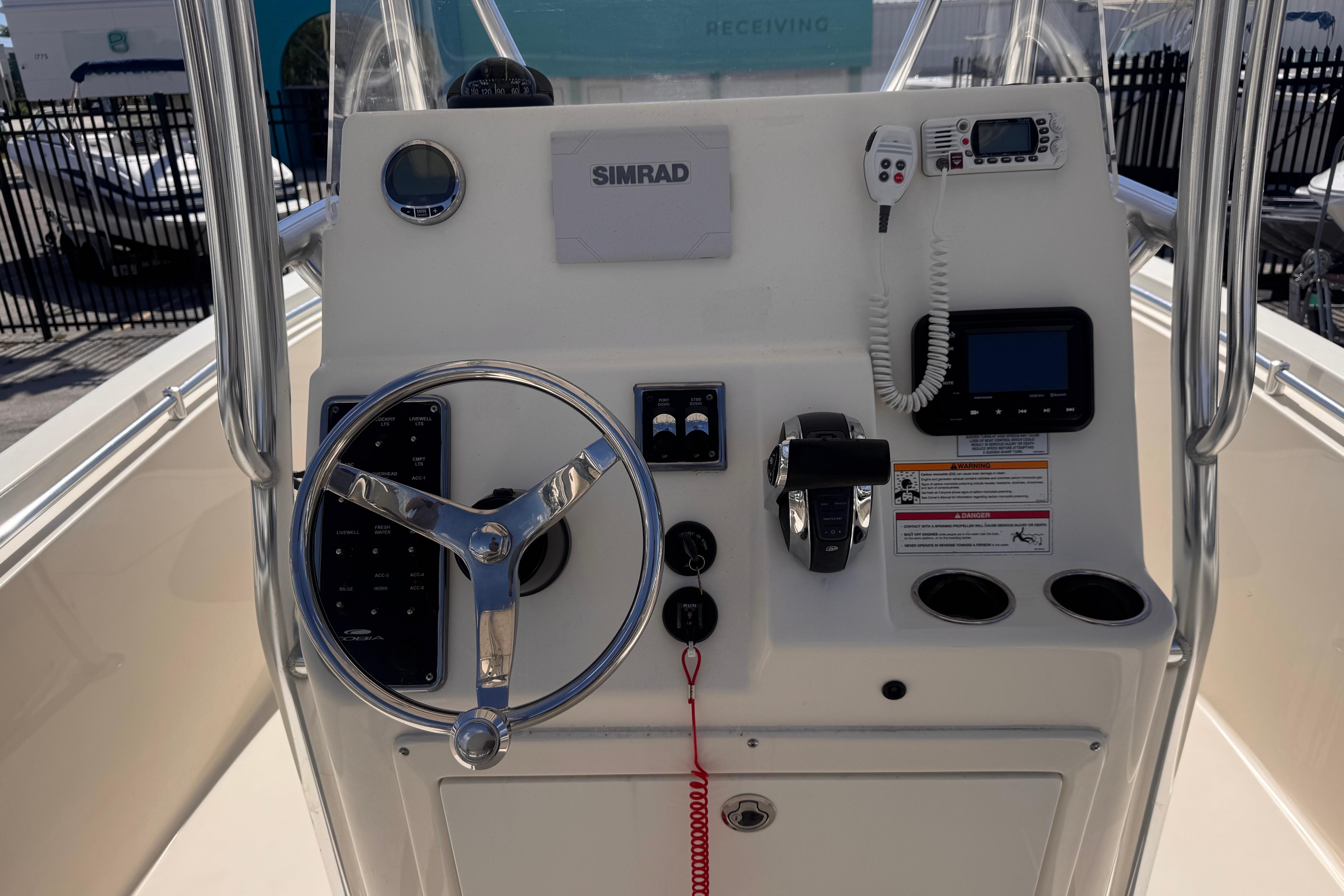 2023 Cobia 237 Center Console boat dashboard with steering wheel and navigation controls.