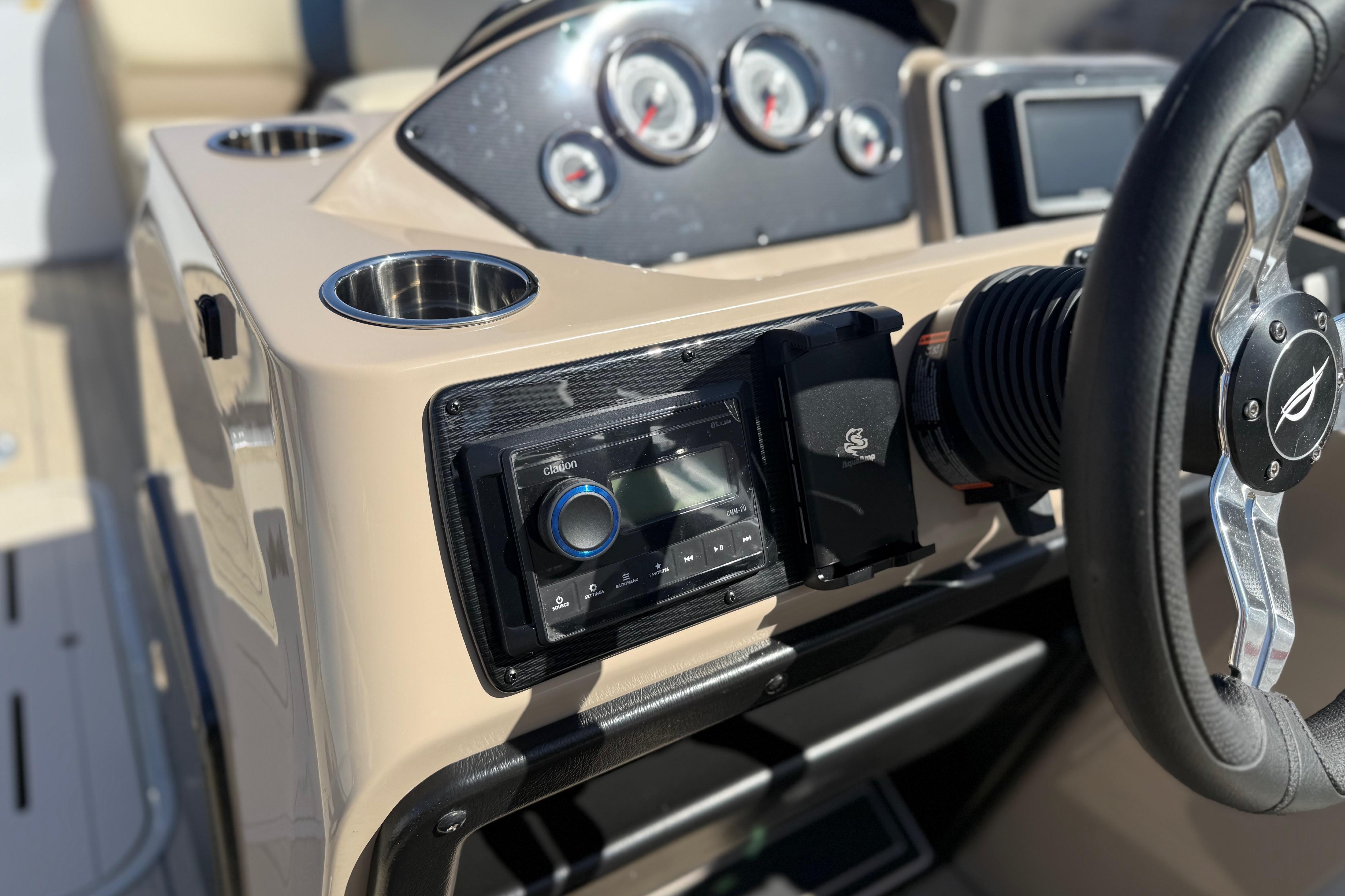 2026 SunCatcher Select 322SL boat dashboard with steering wheel and control panel.