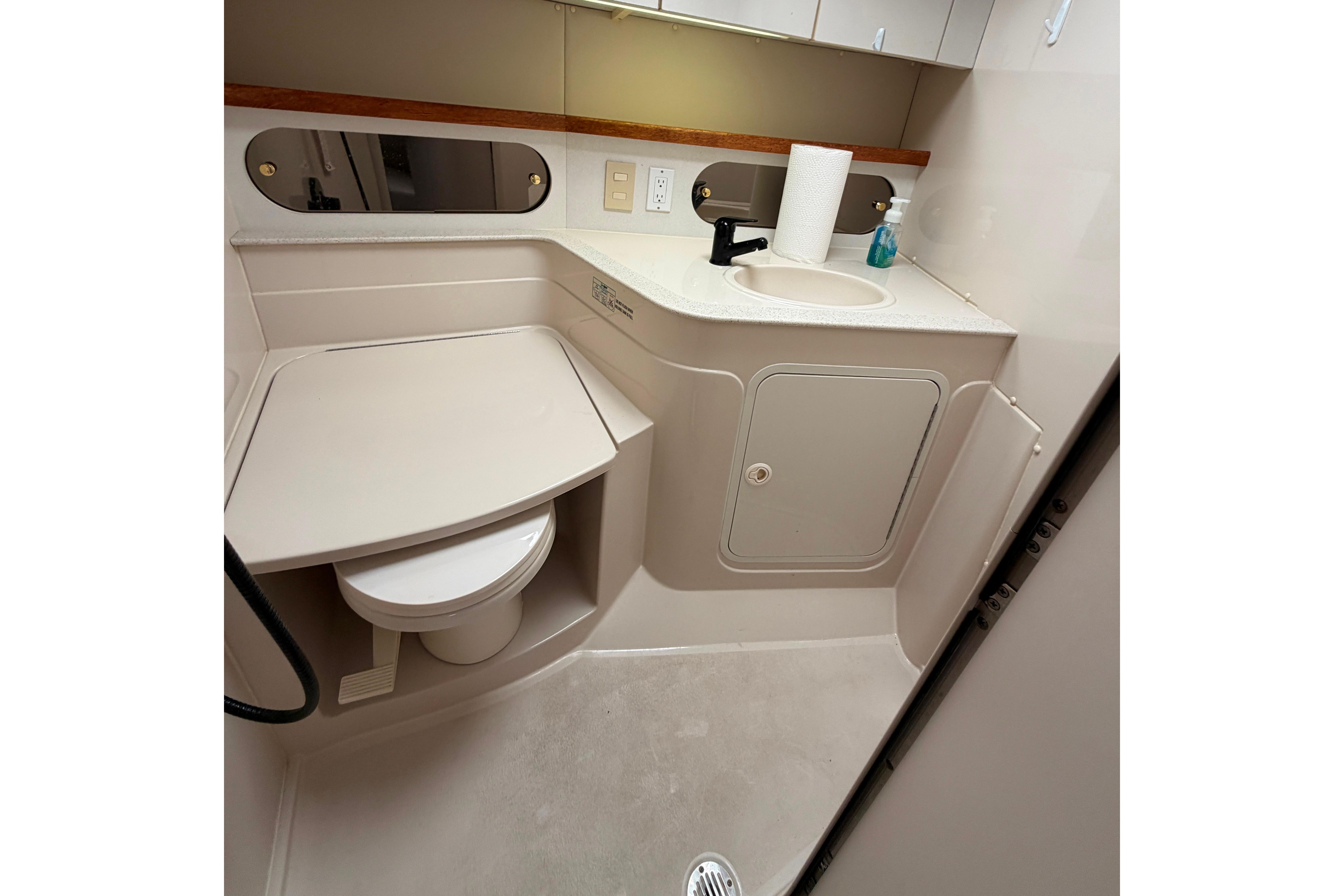 Bathroom interior of a 1997 Cruisers 3575 yacht, featuring sink and toilet.