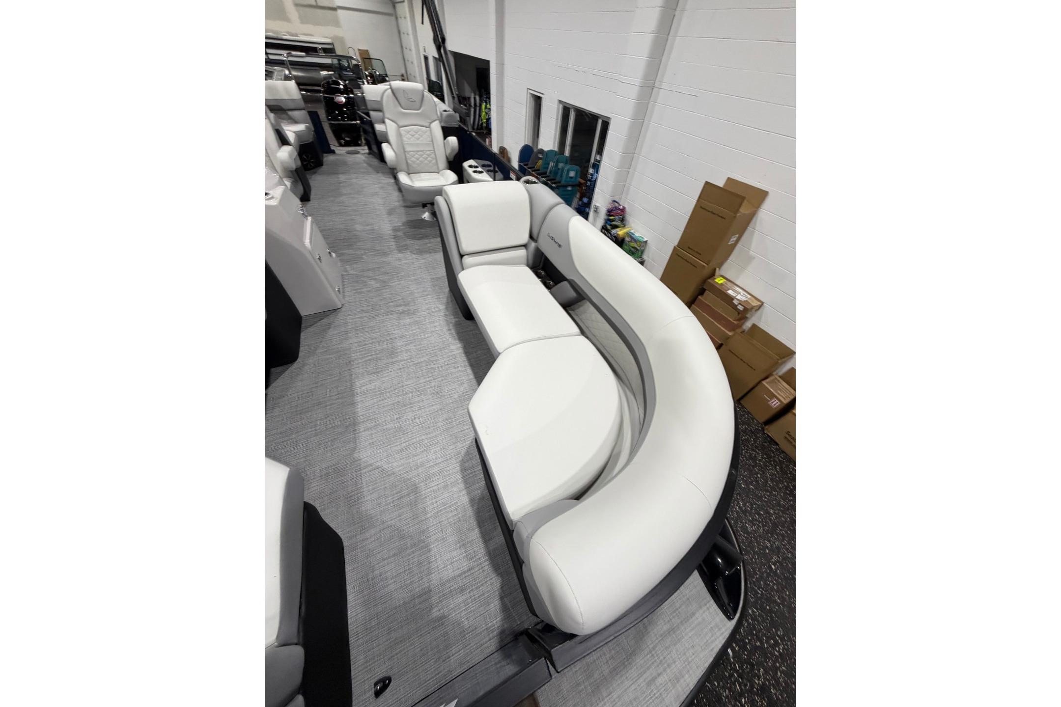 Luxurious seating on 2026 Lowe SS 230 WT pontoon boat, featuring plush white upholstery.