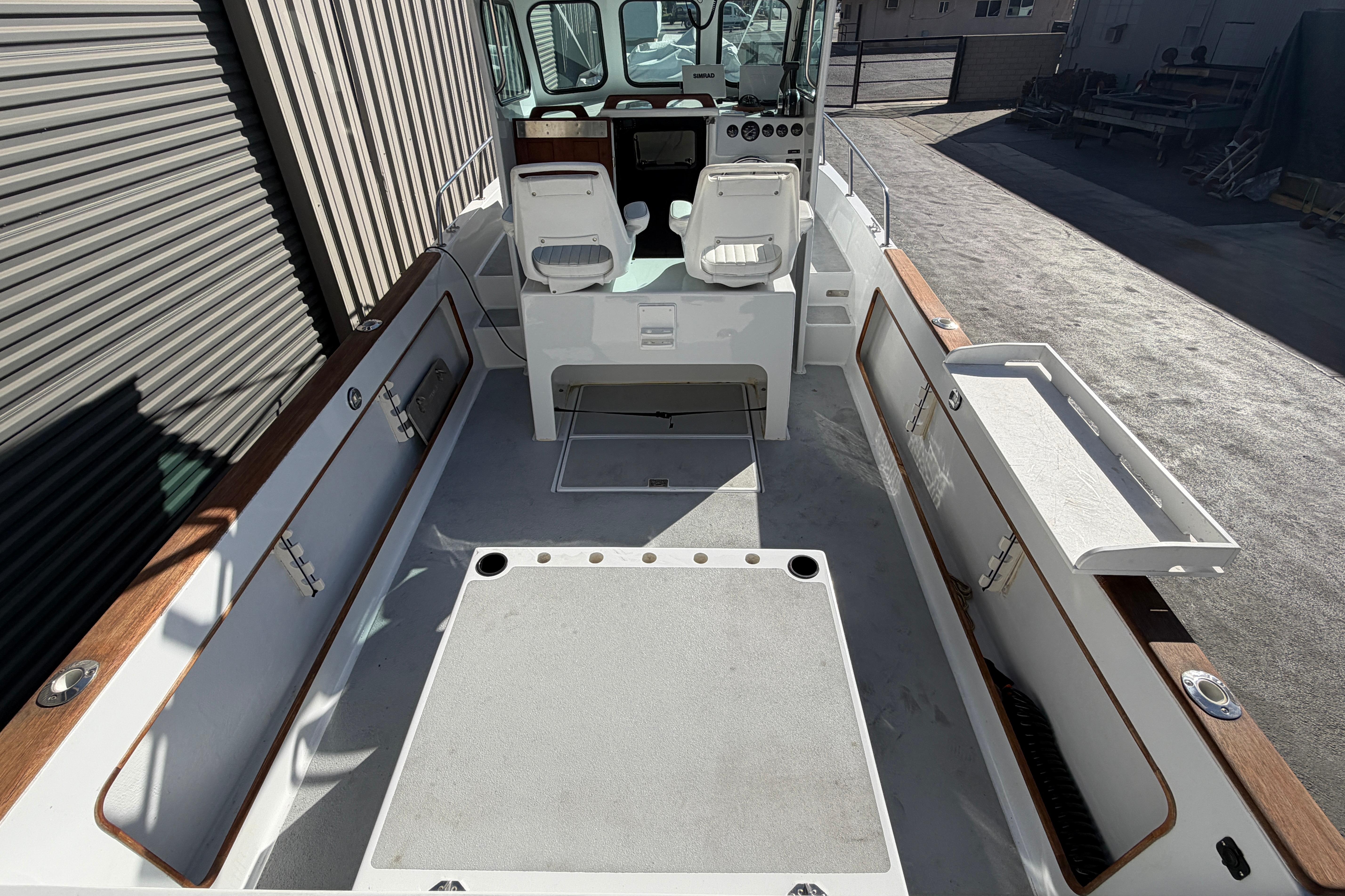 1986 Radon 21 Sport boat interior with seating and storage compartments.