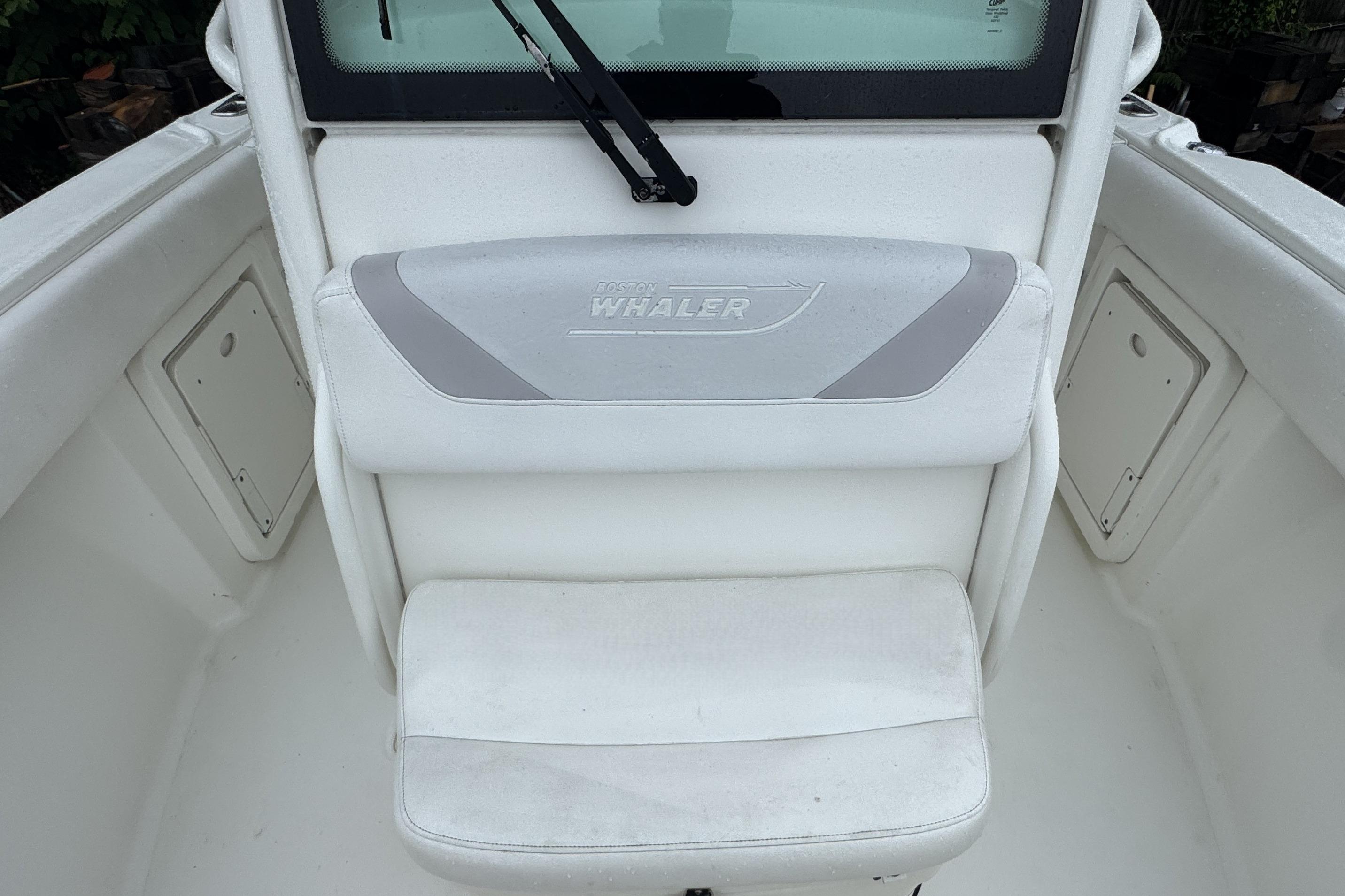 2014 Boston Whaler 250 Outrage boat interior with cushioned seating and storage compartments.