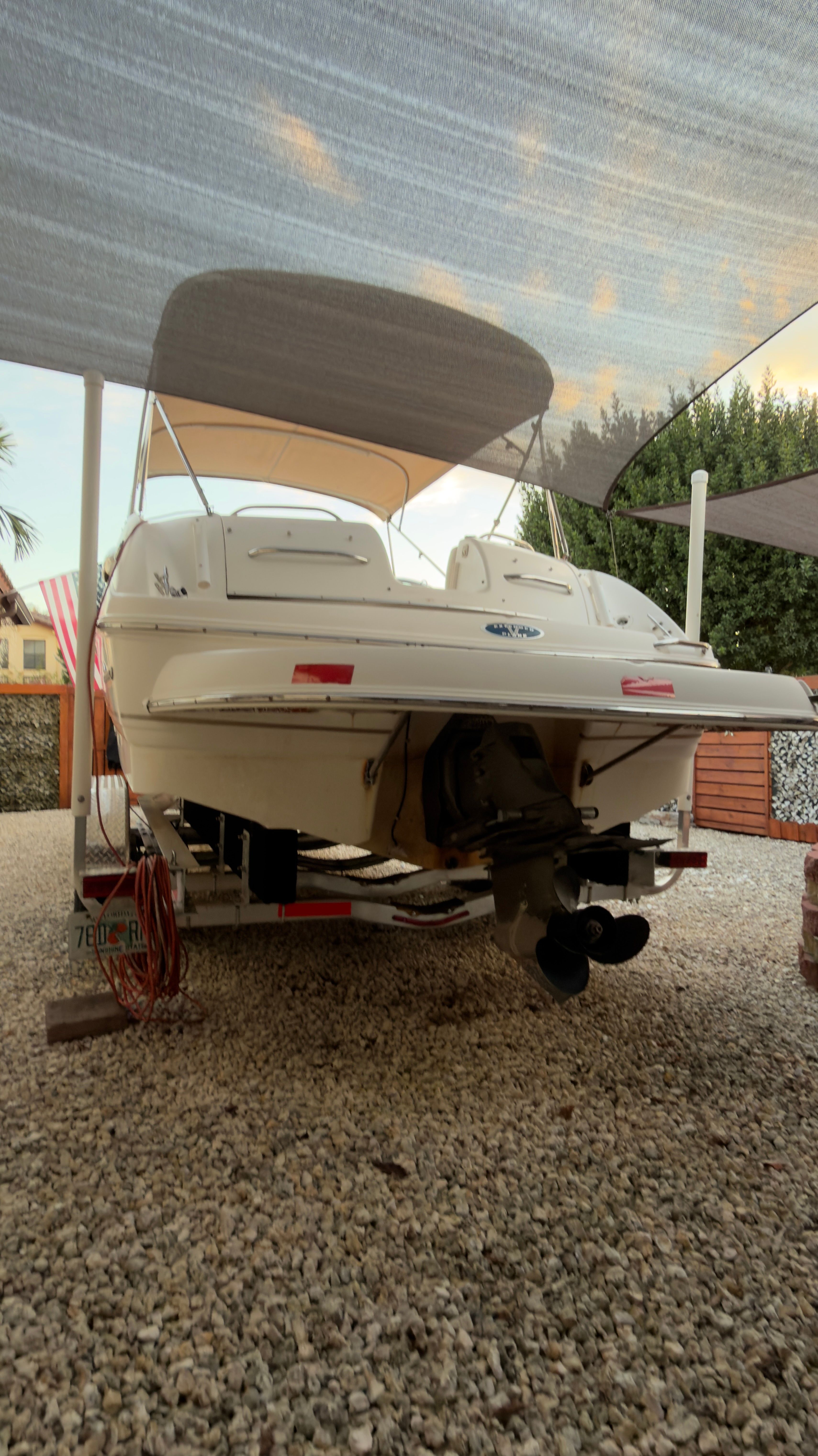 2003 Chaparral 263 Sunesta Deckboat parked on gravel.