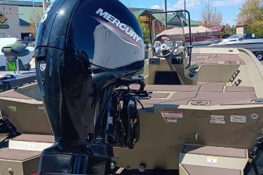 2026 Tracker Grizzly 2072 CC boat with Mercury engine, displayed outdoors.