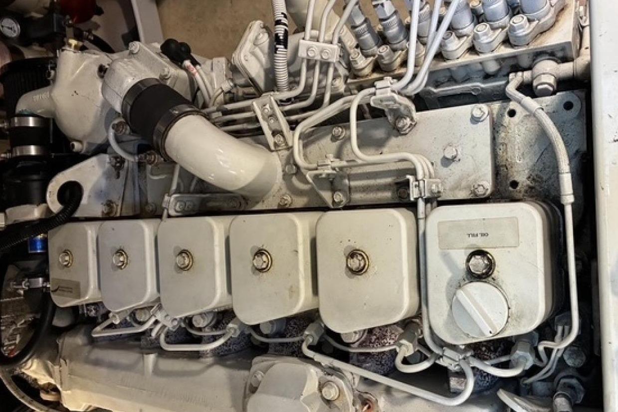 Engine of a 2000 Nordic Tug 37 boat, showcasing mechanical components and piping.