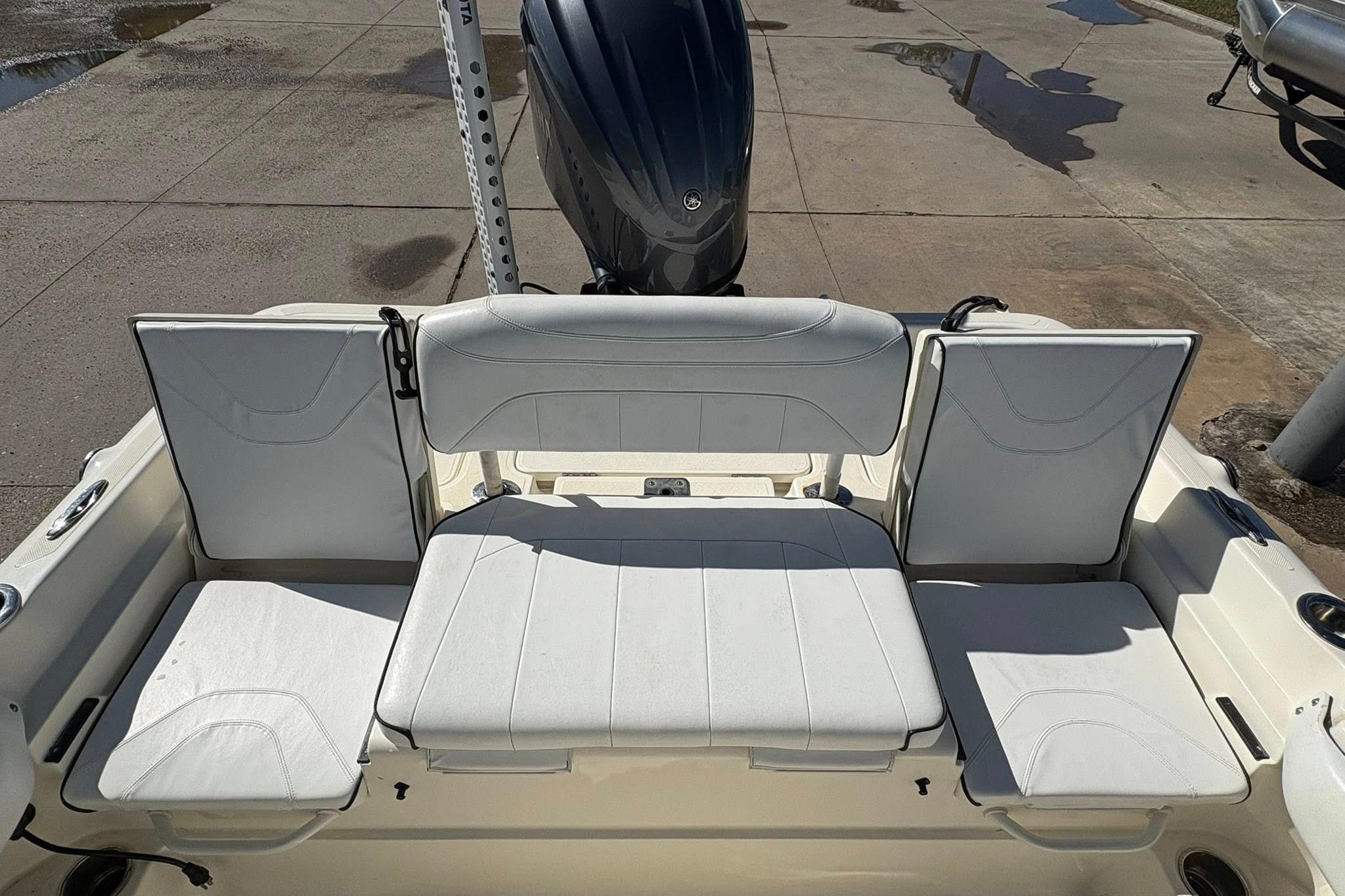 2023 Skeeter SX2550 Family boat with white cushioned seating and motor.