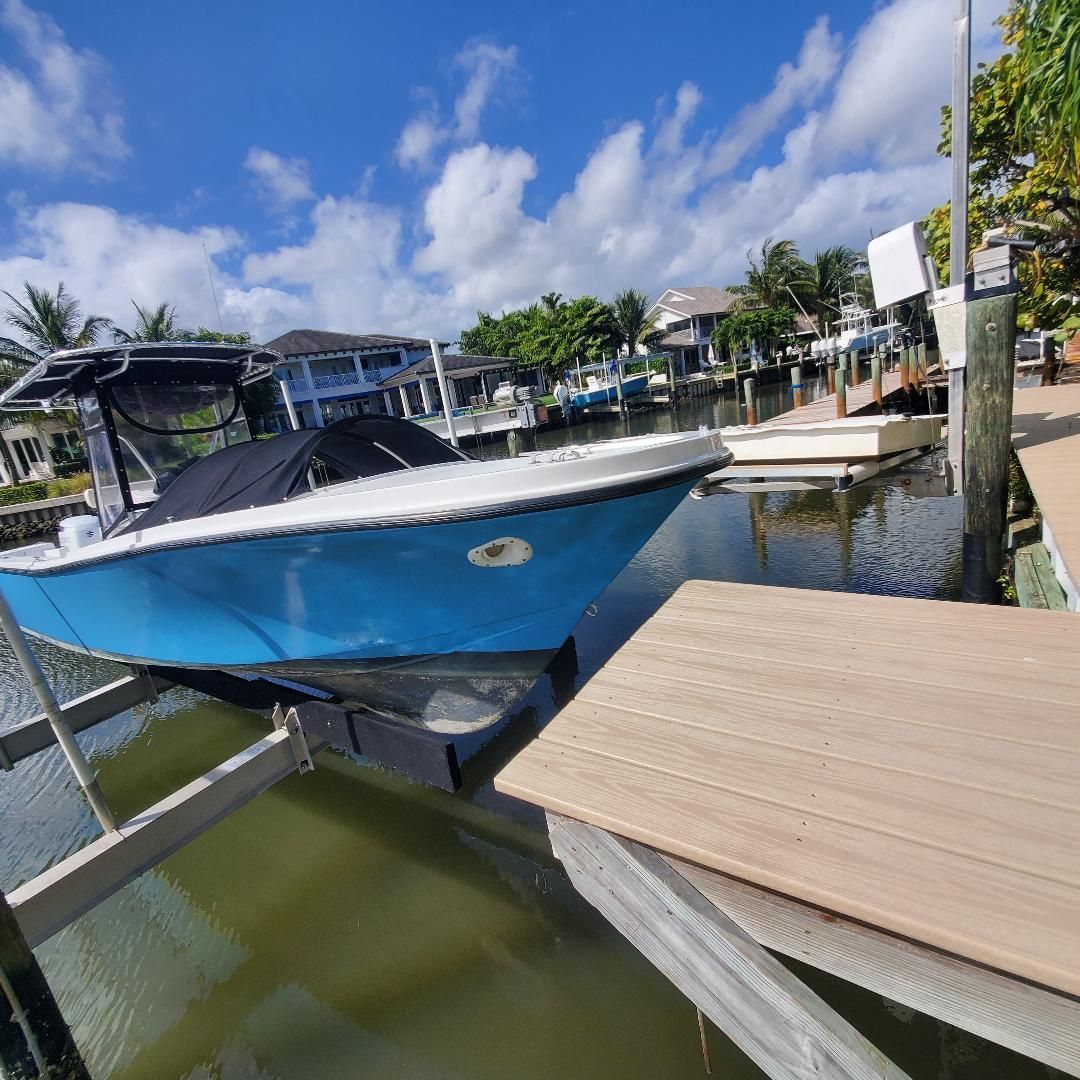 Blue 1981 MASTER MARINE Center Console on boat lift.