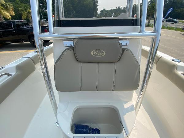 2024 Key West 203 FS boat interior with cushioned seating and storage compartment.