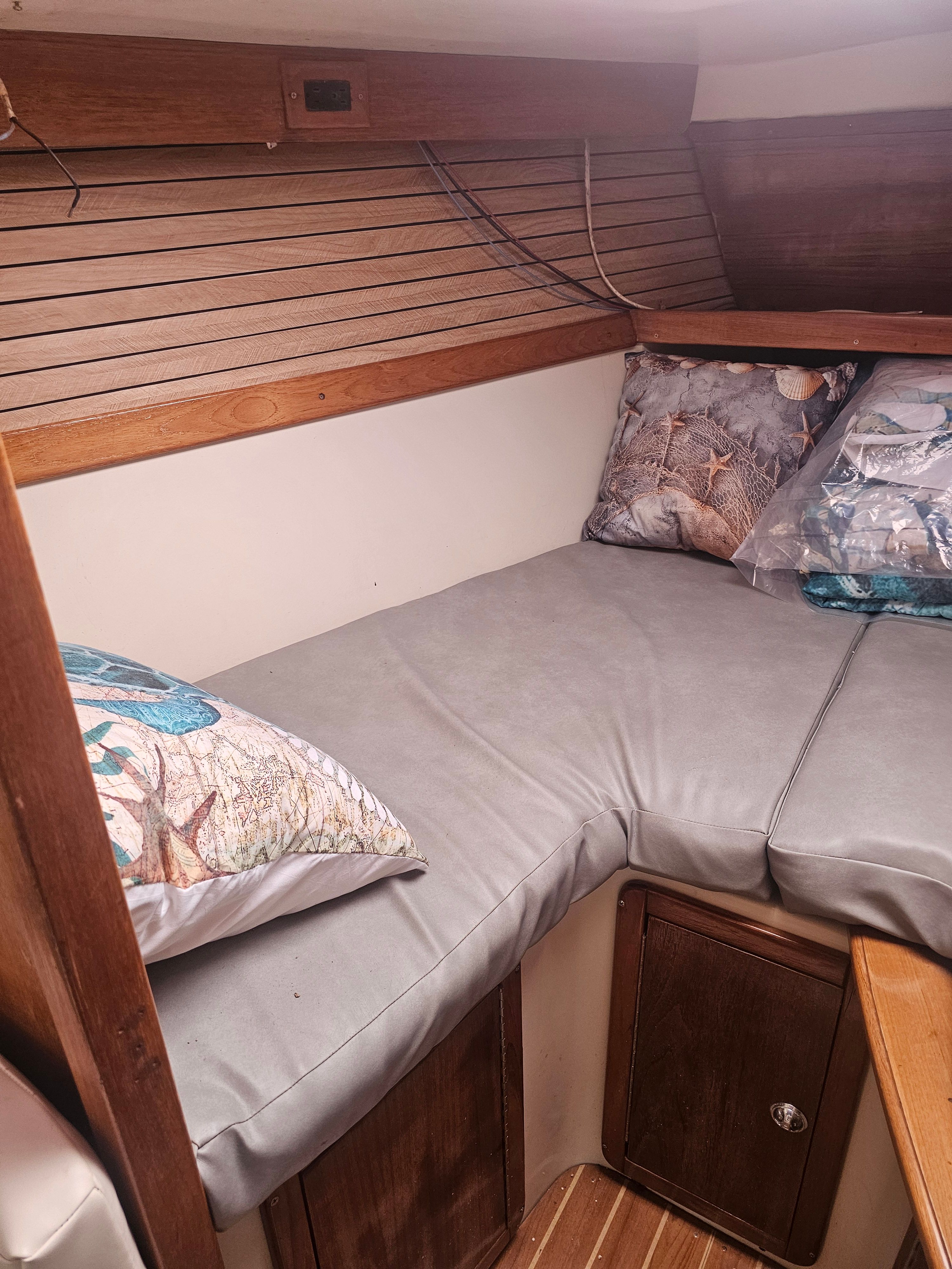 Interior of a Catalina 320 yacht with cozy sleeping cabin.