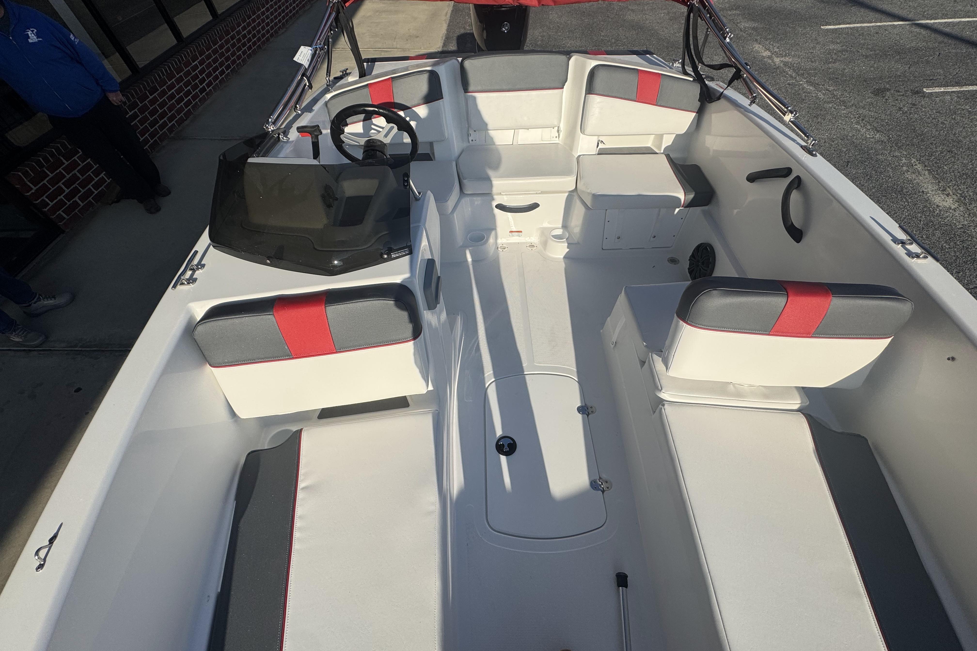 2026 Tahoe T18 boat interior with white and red seating, steering wheel, and dashboard.