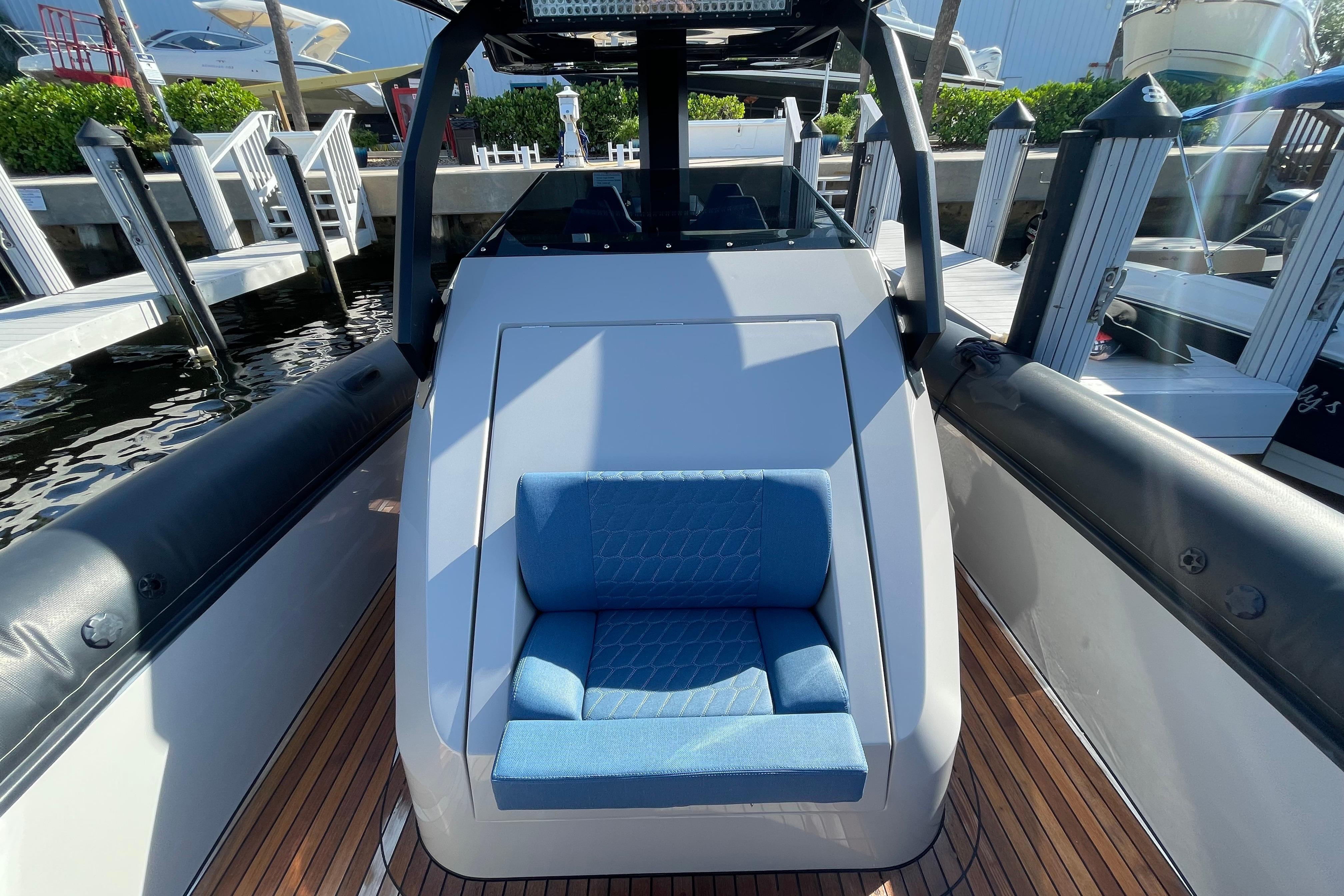 2023 Skipper-BSK BSK 38 boat with blue seating, docked at a marina.