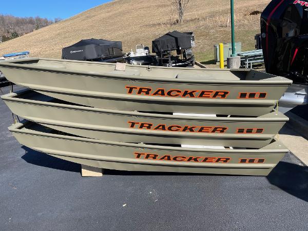 Three stacked 2025 Tracker Grizzly 1036 Utility boats on display outdoors.