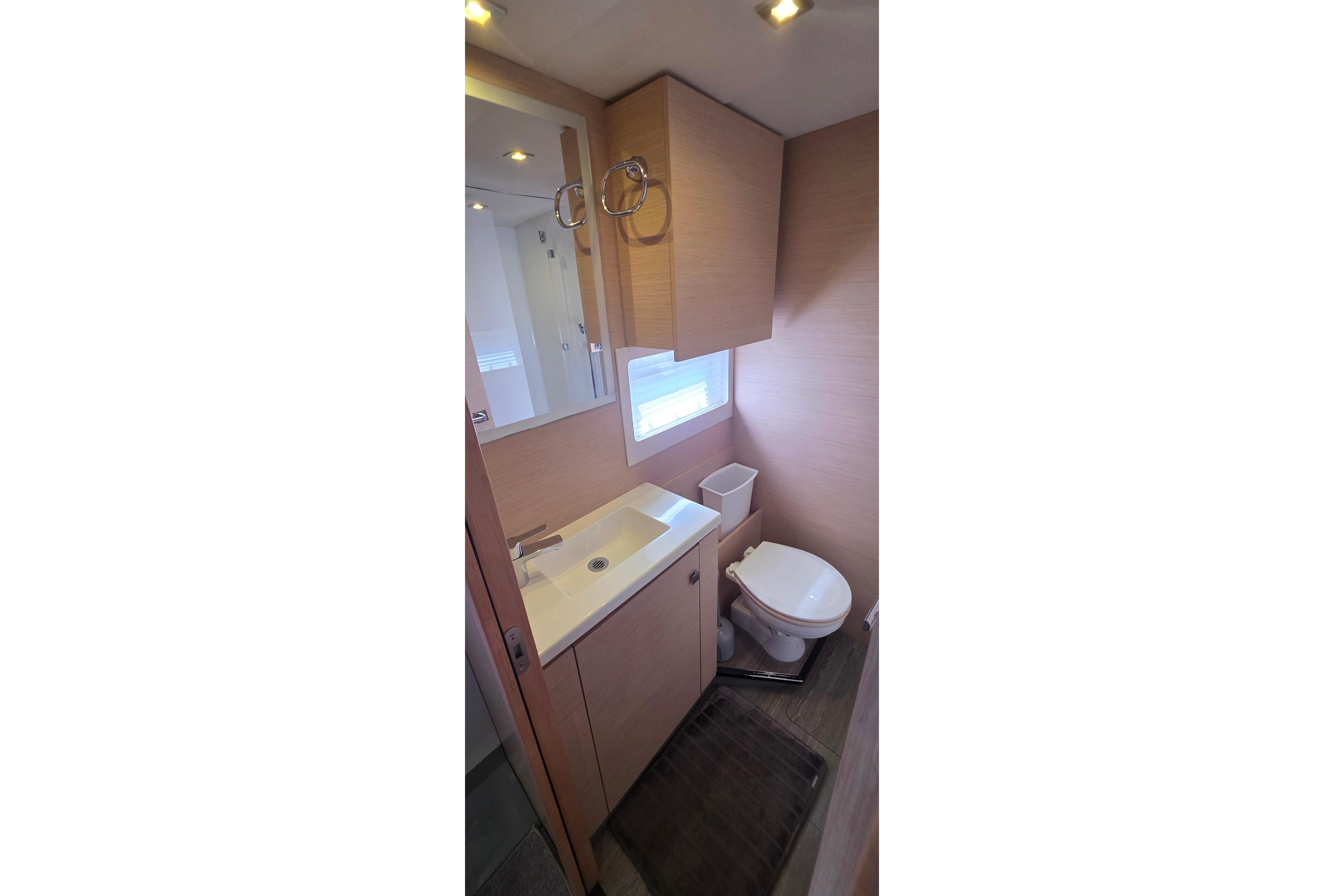 Bathroom interior of 2018 Fountaine Pajot Motor Yacht 44, featuring modern fixtures and wood accents.