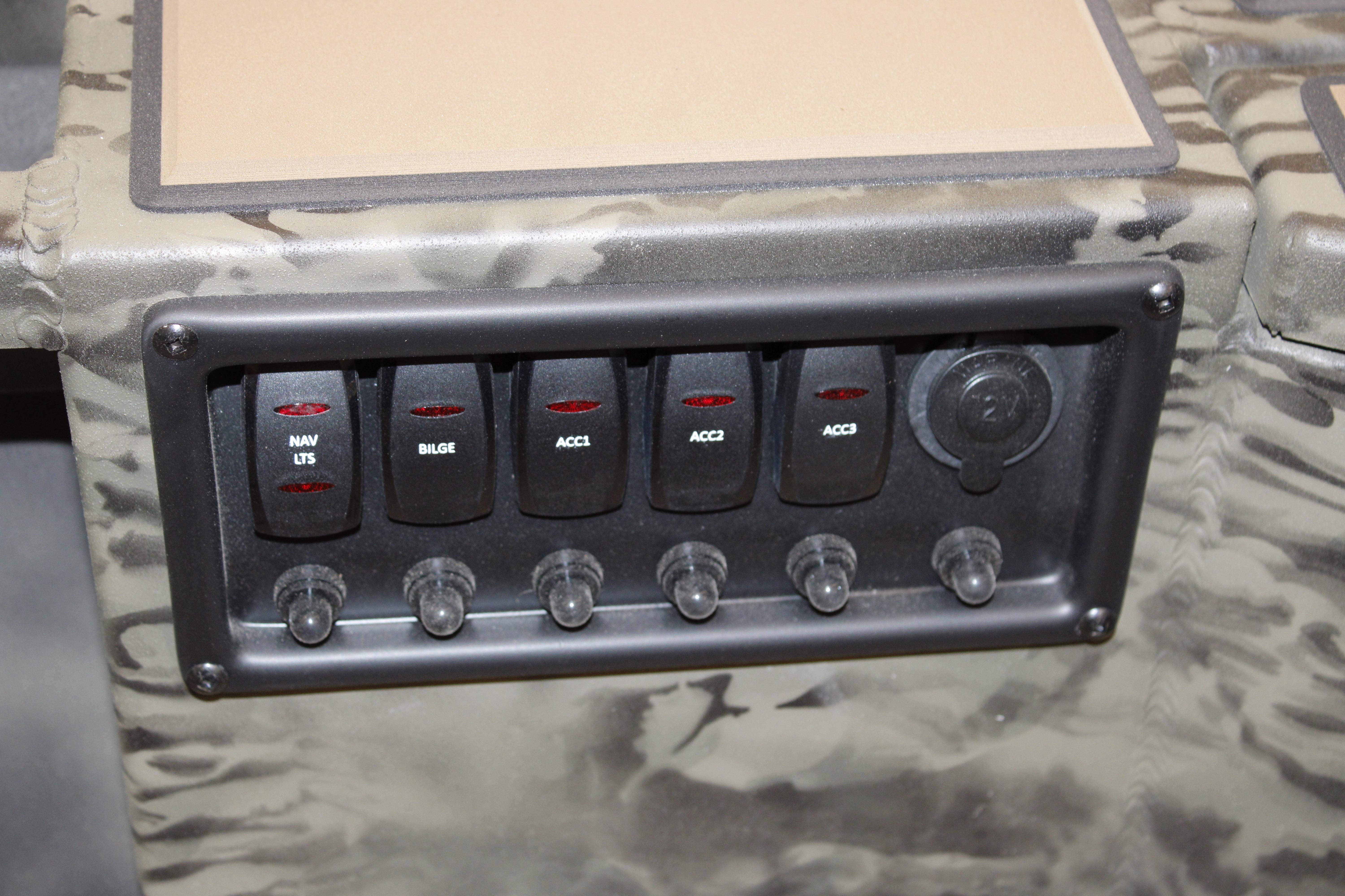 Control panel of 2026 Tracker Grizzly 1756 T Marsh boat with switches for navigation and accessories.