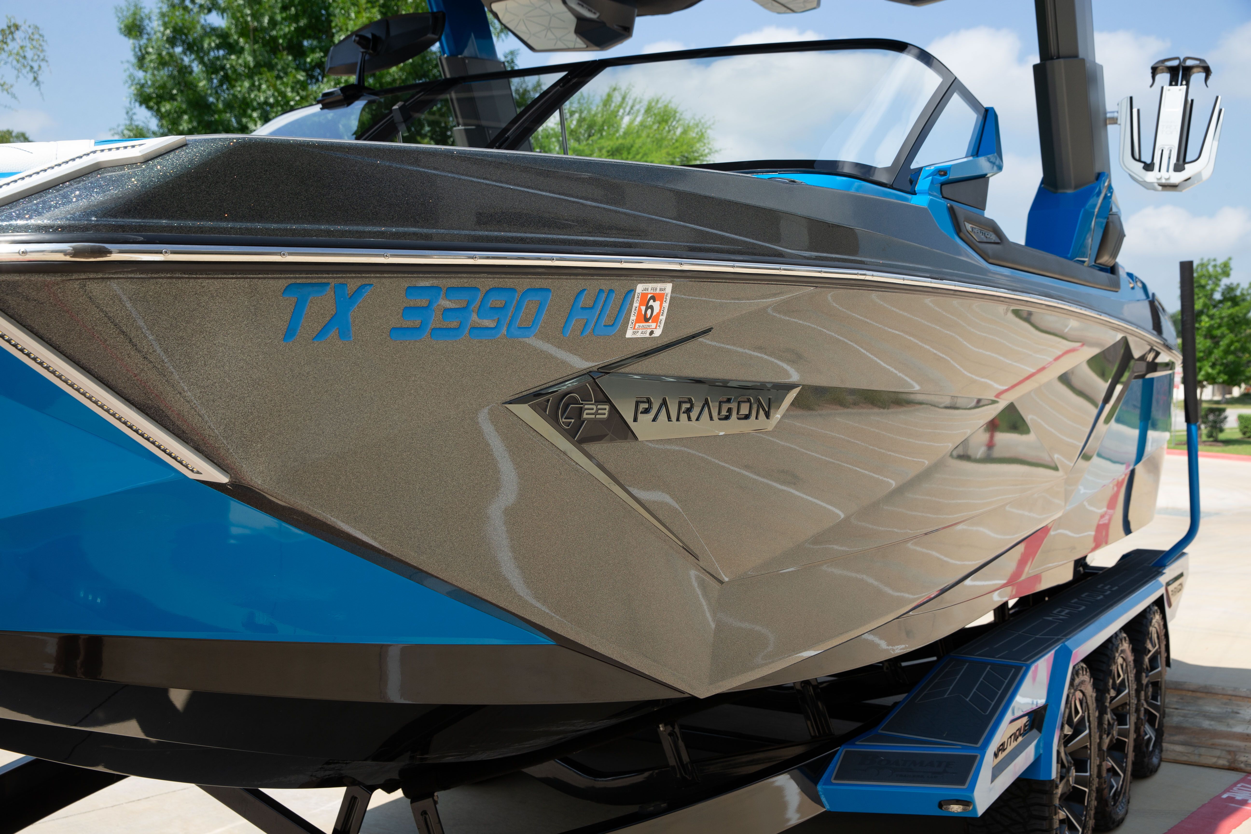 A blue and gray boat on a trailer, featuring "G23 Paragon" lettering.