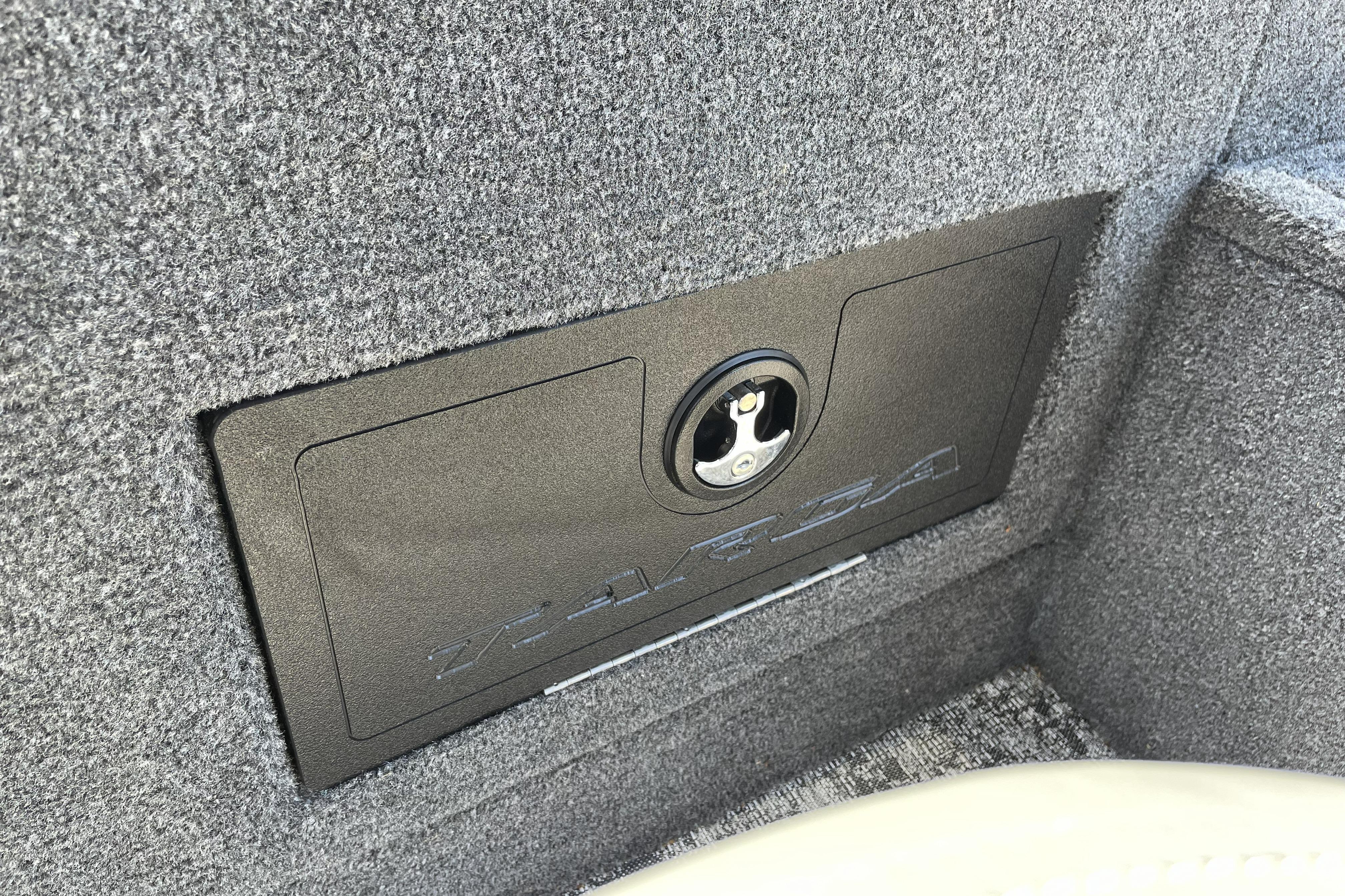 2026 Tracker Targa V-18 WT boat storage compartment with secure lock mechanism.