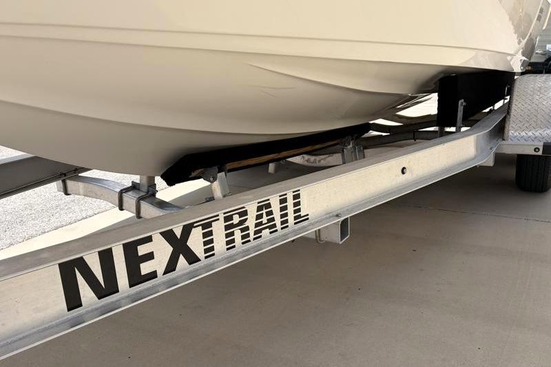 2023 Key West 203 FS boat on NexTrail trailer, close-up view.