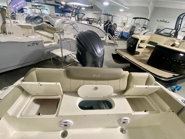 2024 Key West 219 FS boat interior with Yamaha outboard motor in showroom.