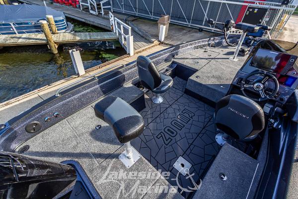 2024 Recon 985 SC fishing boat at dock, featuring spacious deck and modern seating.