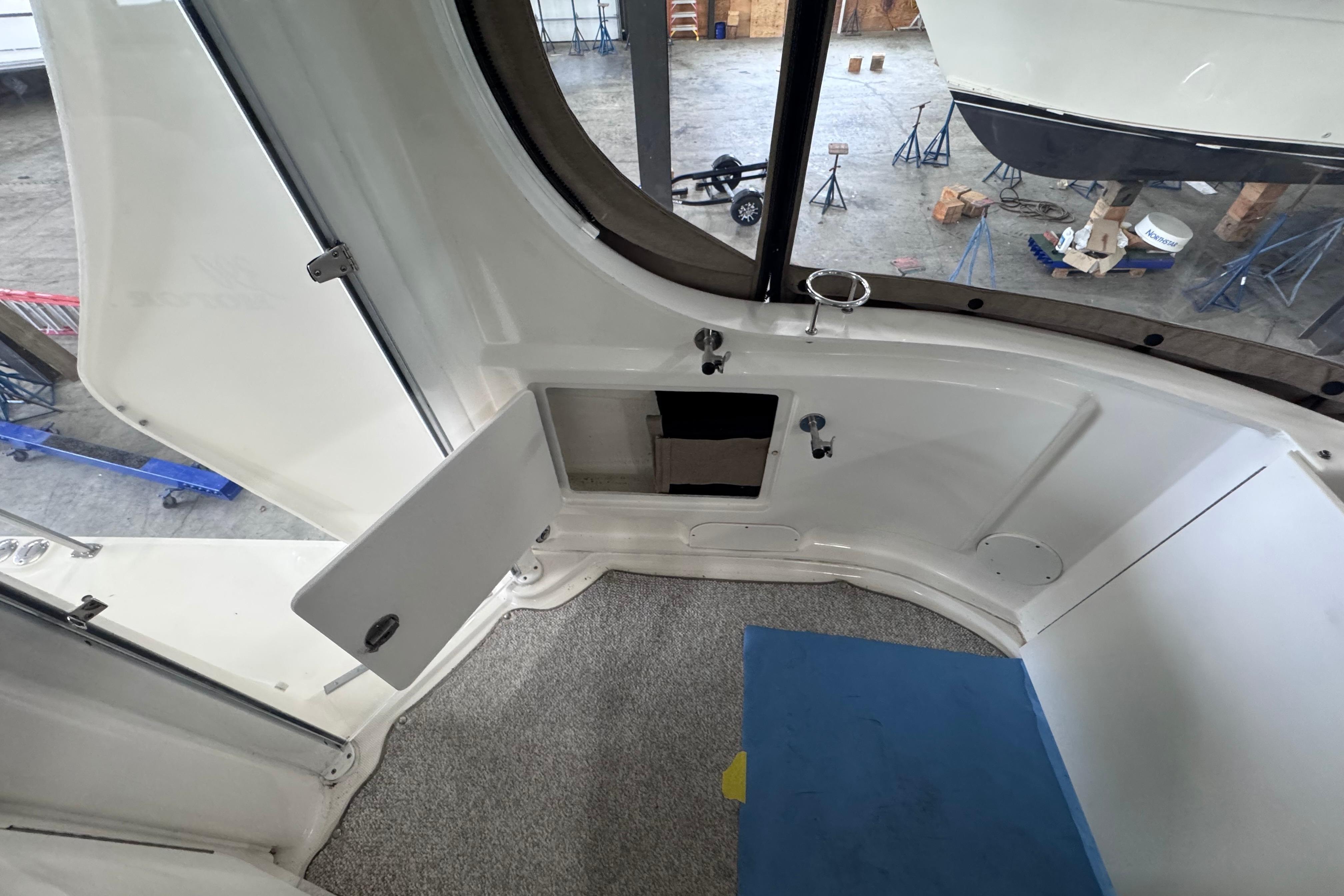 2004 Sea Ray 390 Motor Yacht interior with open hatch and storage compartment.