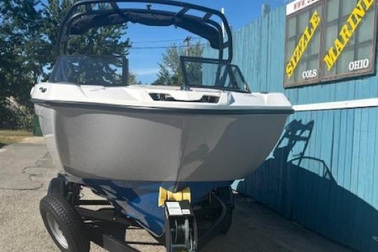 2026 Yamaha Boats AR220 on trailer, parked outdoors near blue fence.