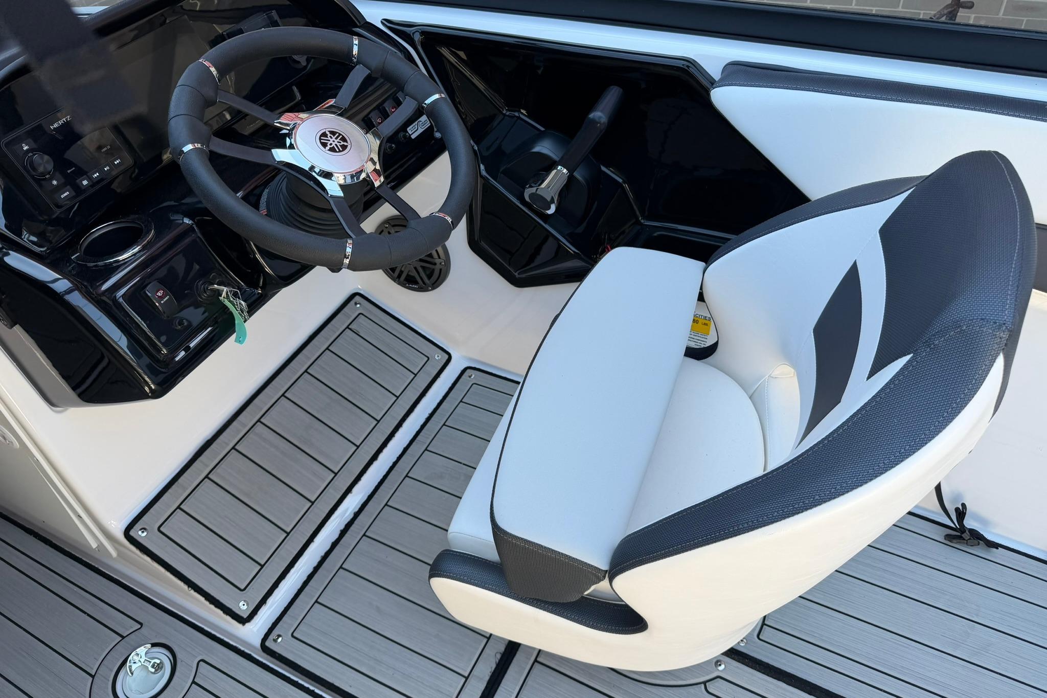 2024 Yamaha Boats AR190 cockpit with steering wheel and captain's chair.