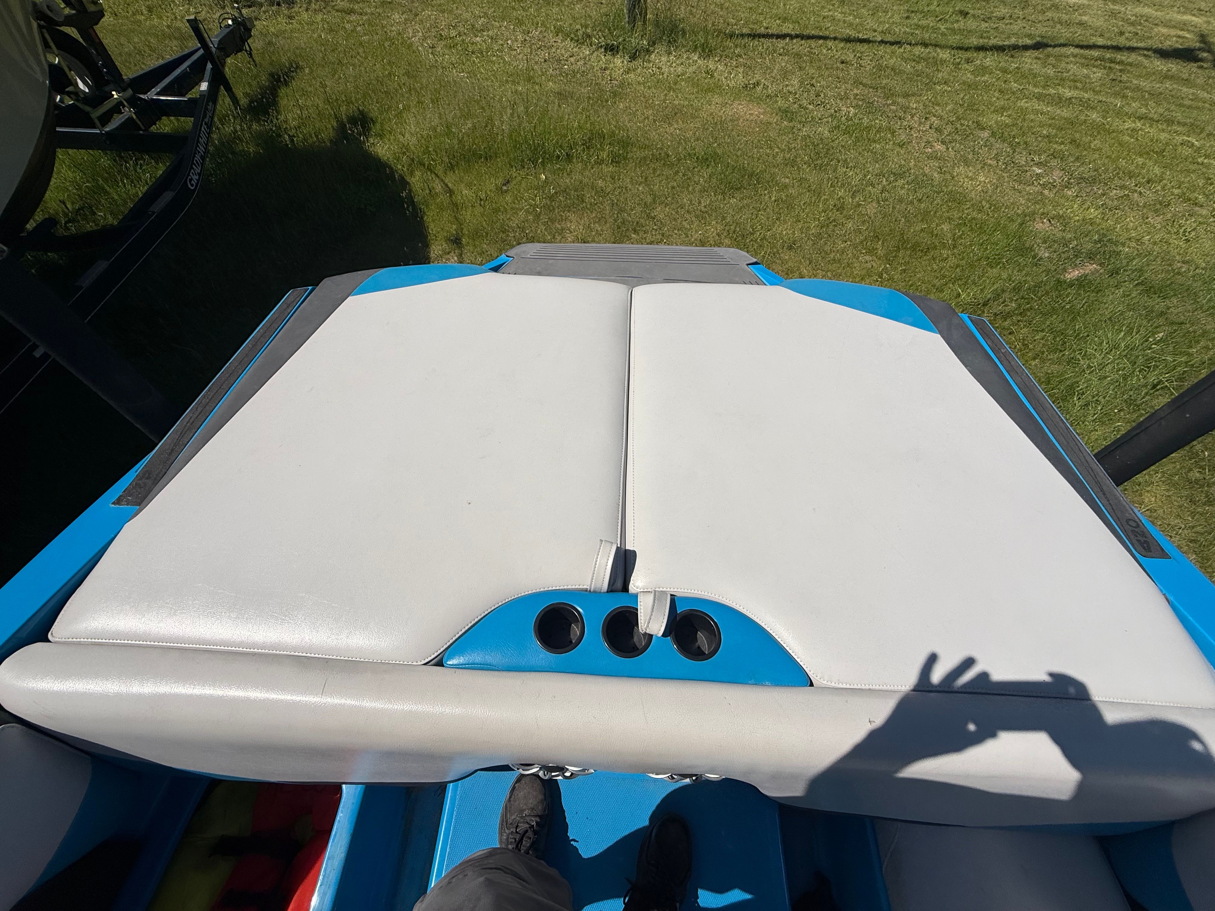 Rear view of a 2015 Malibu Axis A20 boat on grass.