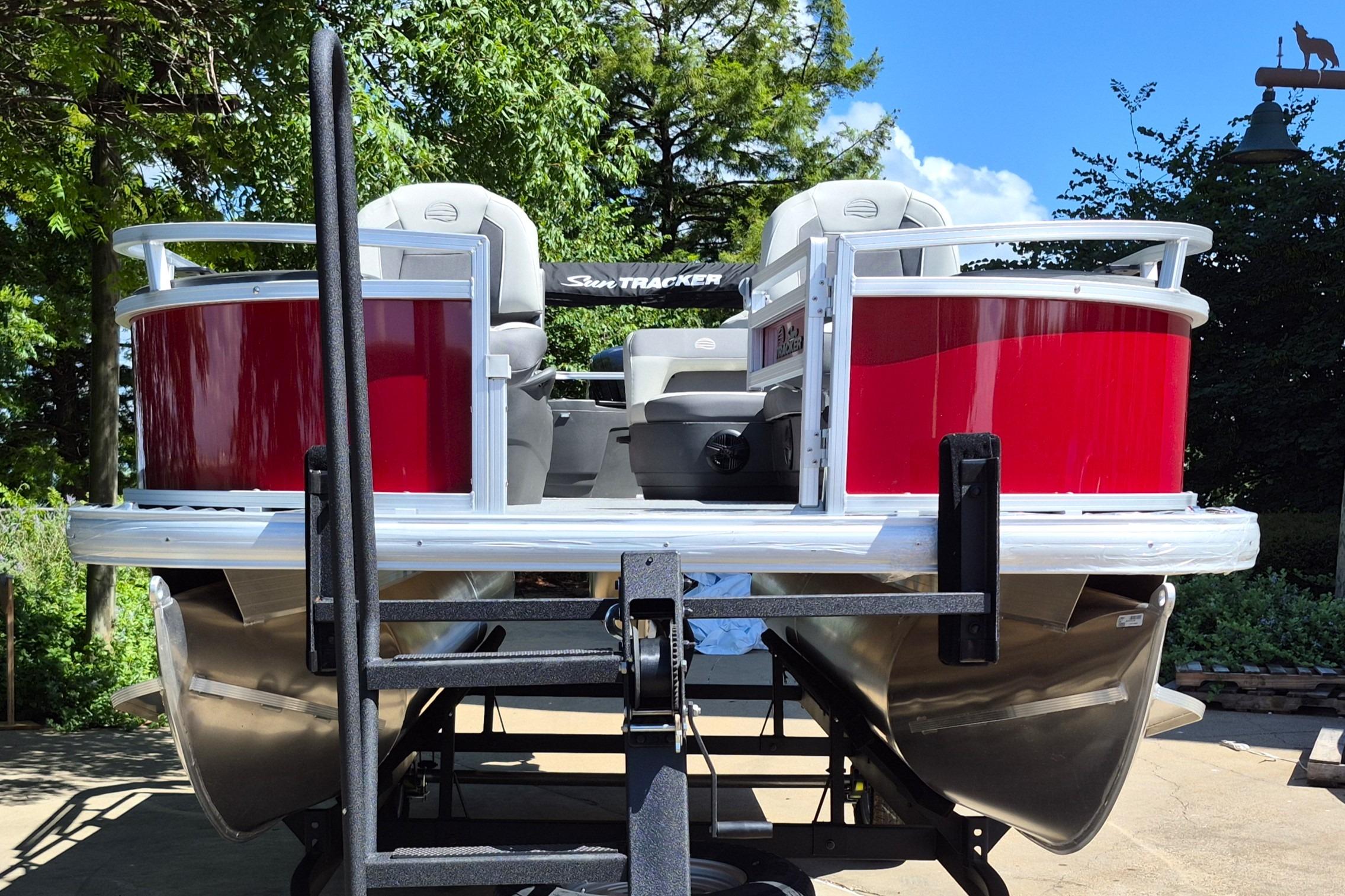 2026 Sun Tracker Bass Buggy 18 DLX pontoon boat on trailer, rear view.