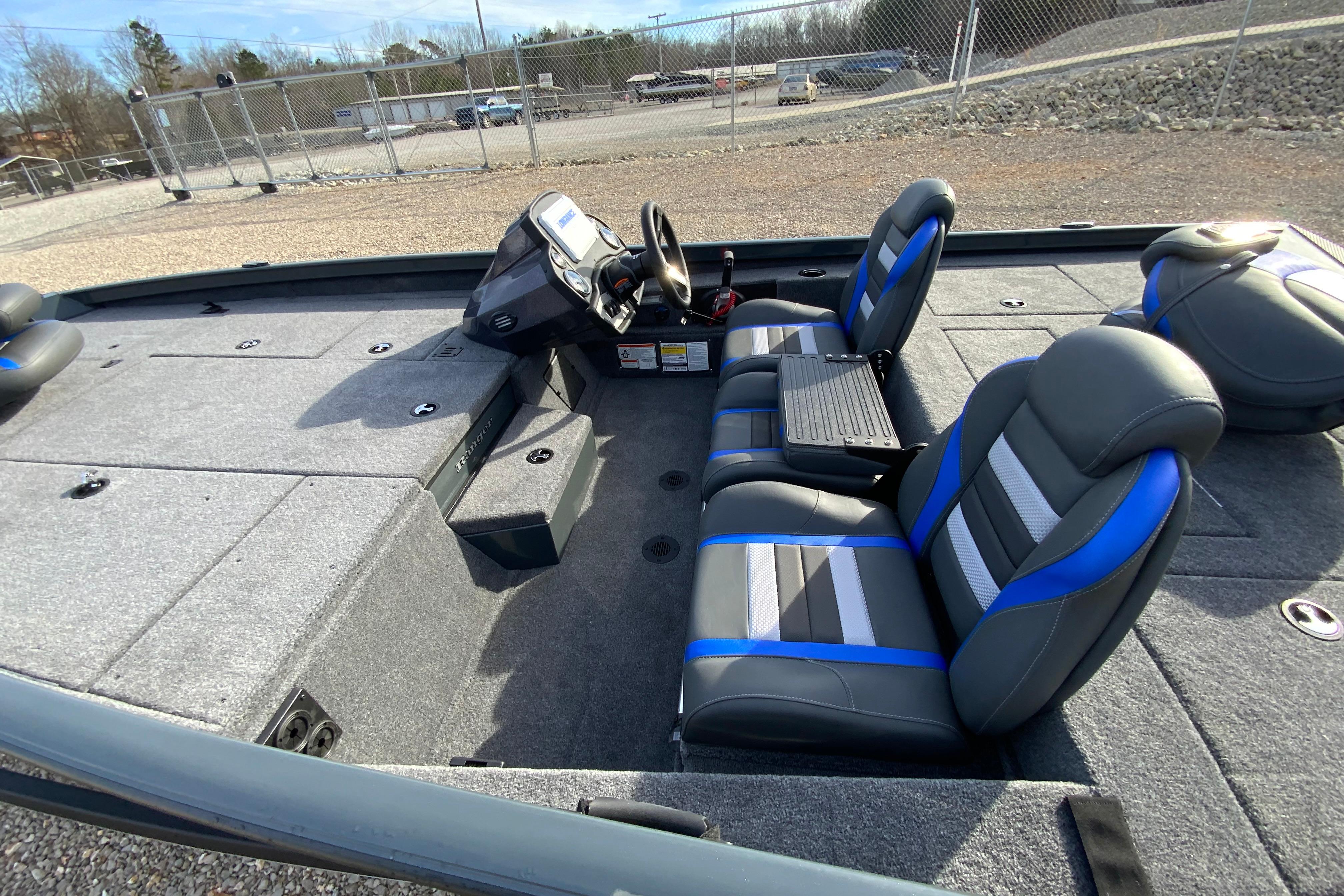 2026 Ranger RT198P boat interior with gray and blue seating, steering console, and spacious deck.