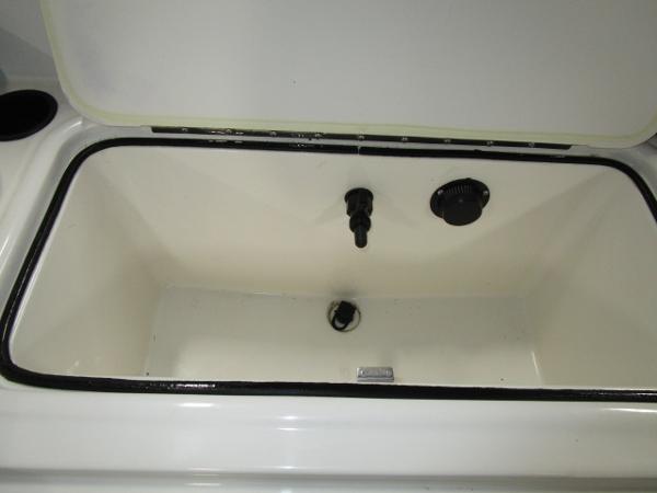 Open storage compartment in 2023 Bayliner 210EL boat.