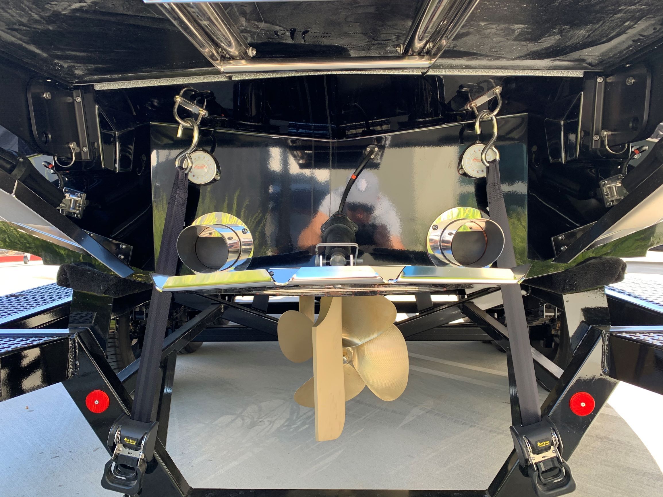 Rear view of a MasterCraft X24 boat with visible propeller and exhausts.