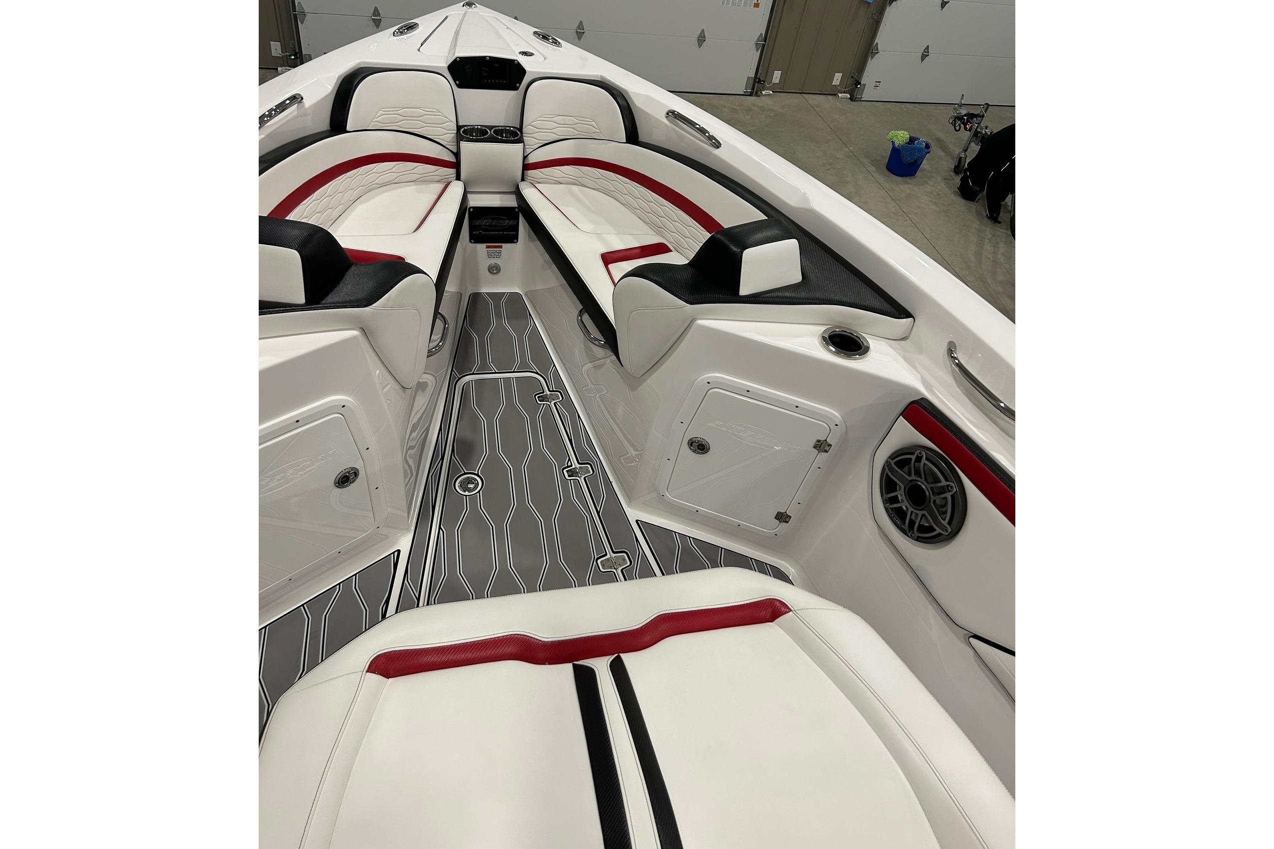 2023 Sunsation 32 CCX boat interior with red and black accents, modern seating, and sleek design.