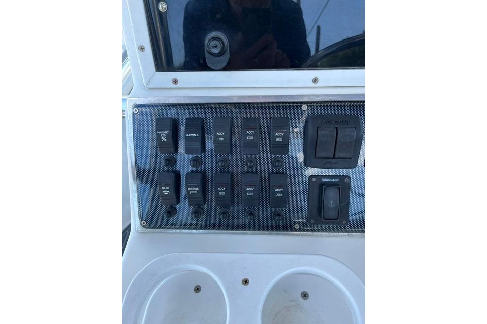 Control panel of a 1999 Dusky 256 Center Console boat with switches.