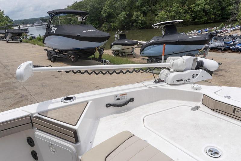 2023 Yamaha Boats 195 FSH Sport with Minn Kota trolling motor, docked near other boats.