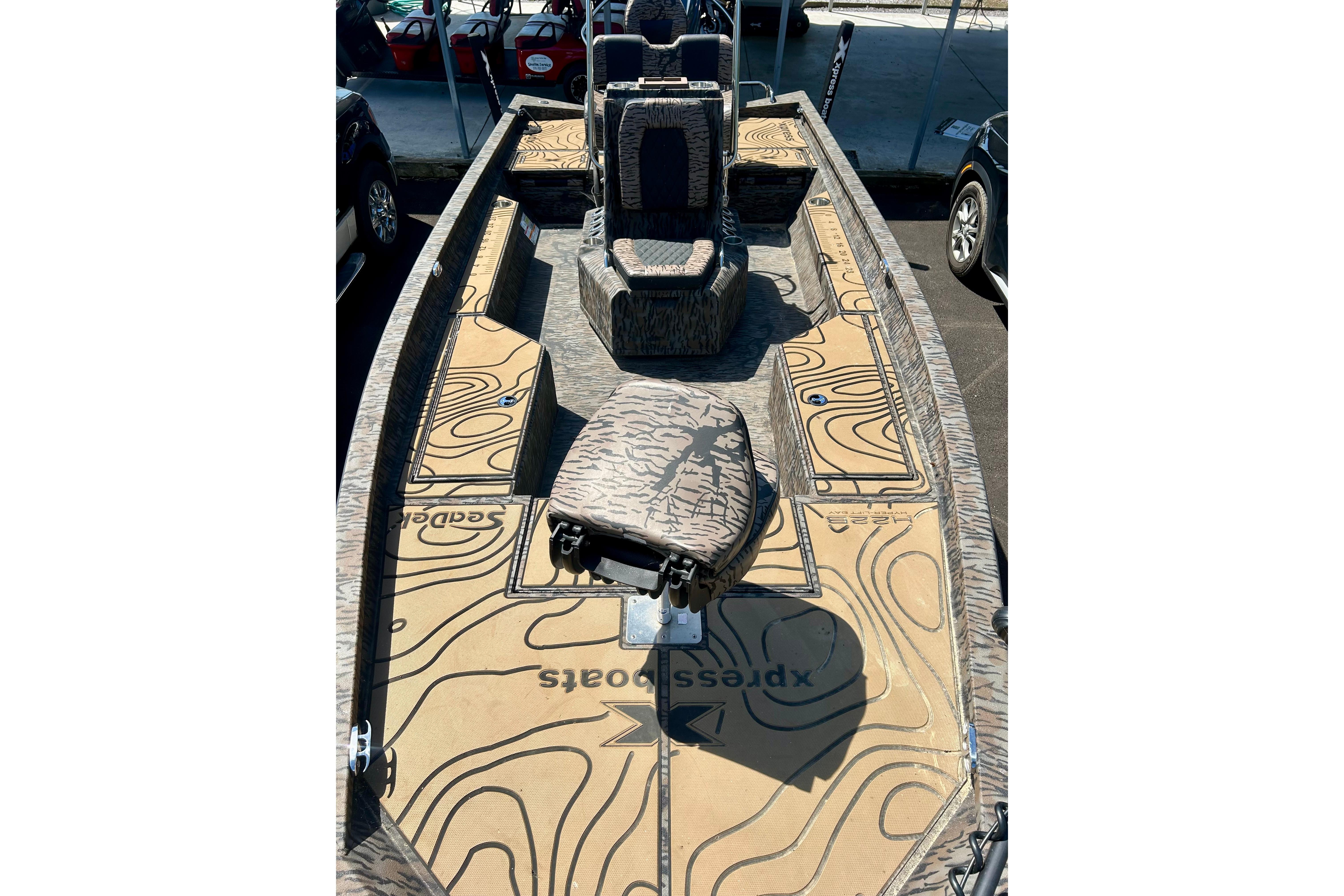 2025 Xpress H22B Bay boat interior with camouflage design and spacious seating.