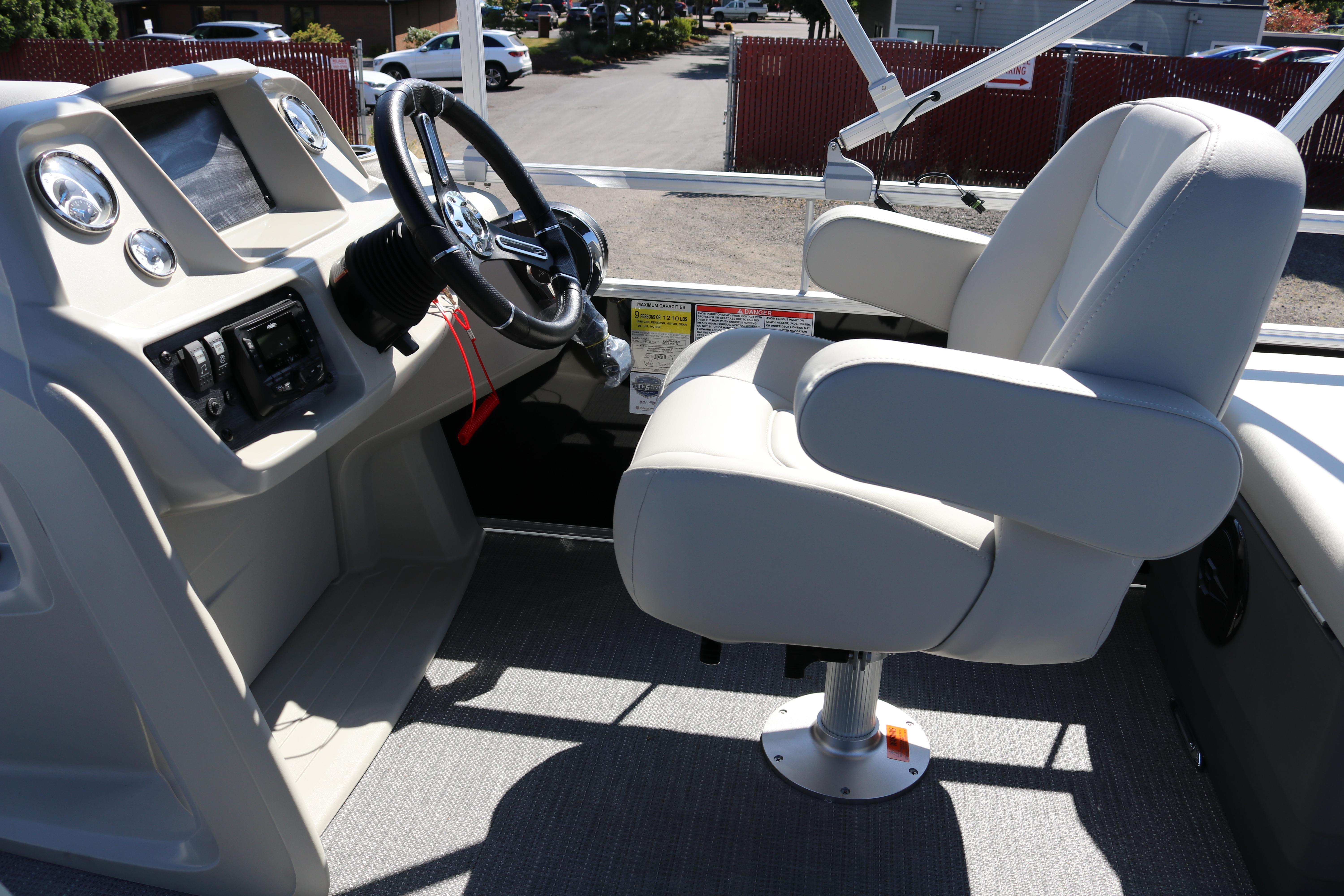 2025 SunChaser Vista 20 Fish boat interior with steering console and captain's chair.