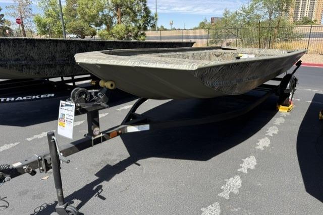 2026 Tracker Grizzly 1860 Utility boat on trailer, parked outdoors in a sunny setting.
