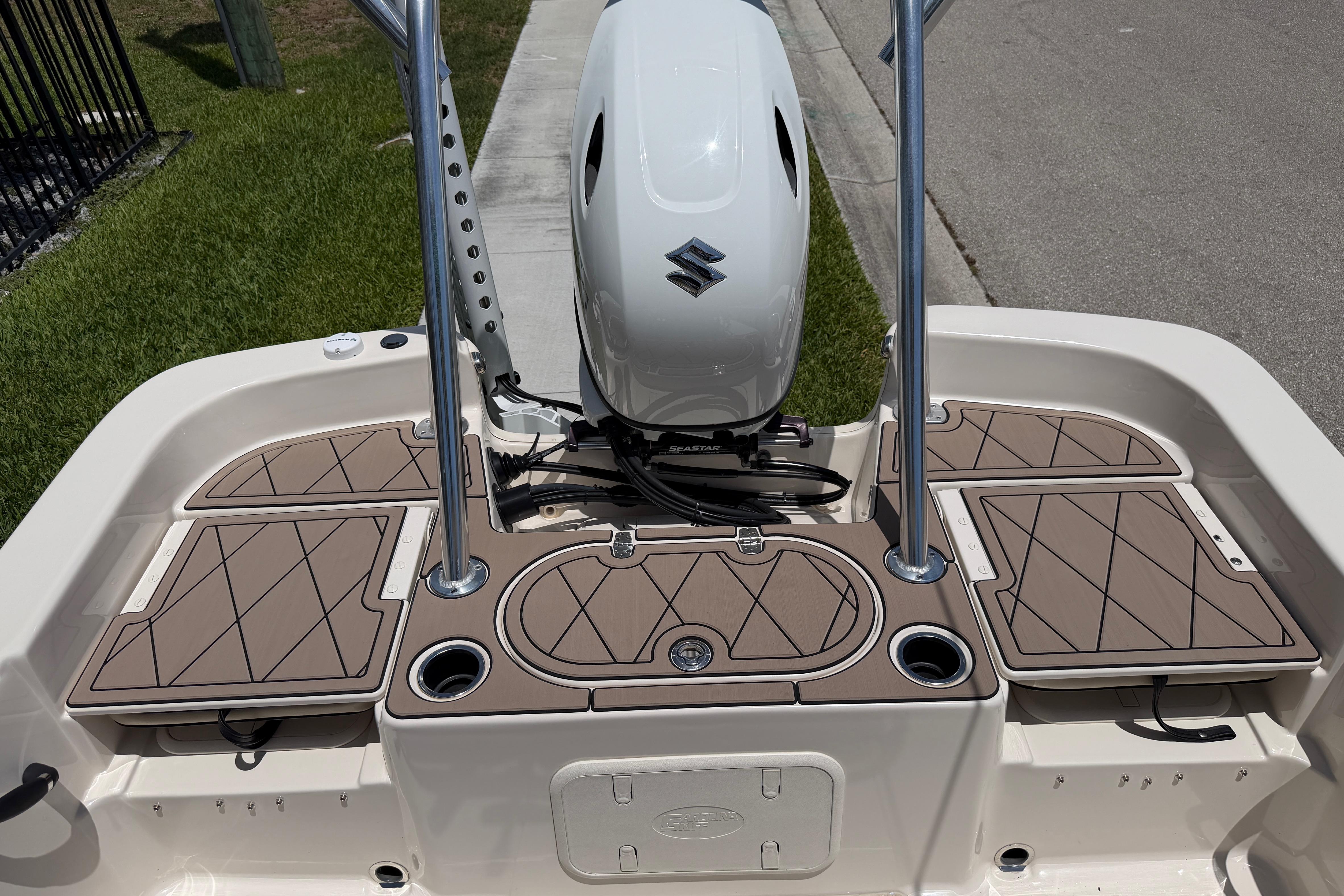 2023 Carolina Skiff 21 LS boat deck with Suzuki outboard motor, featuring tan cushioned seating.