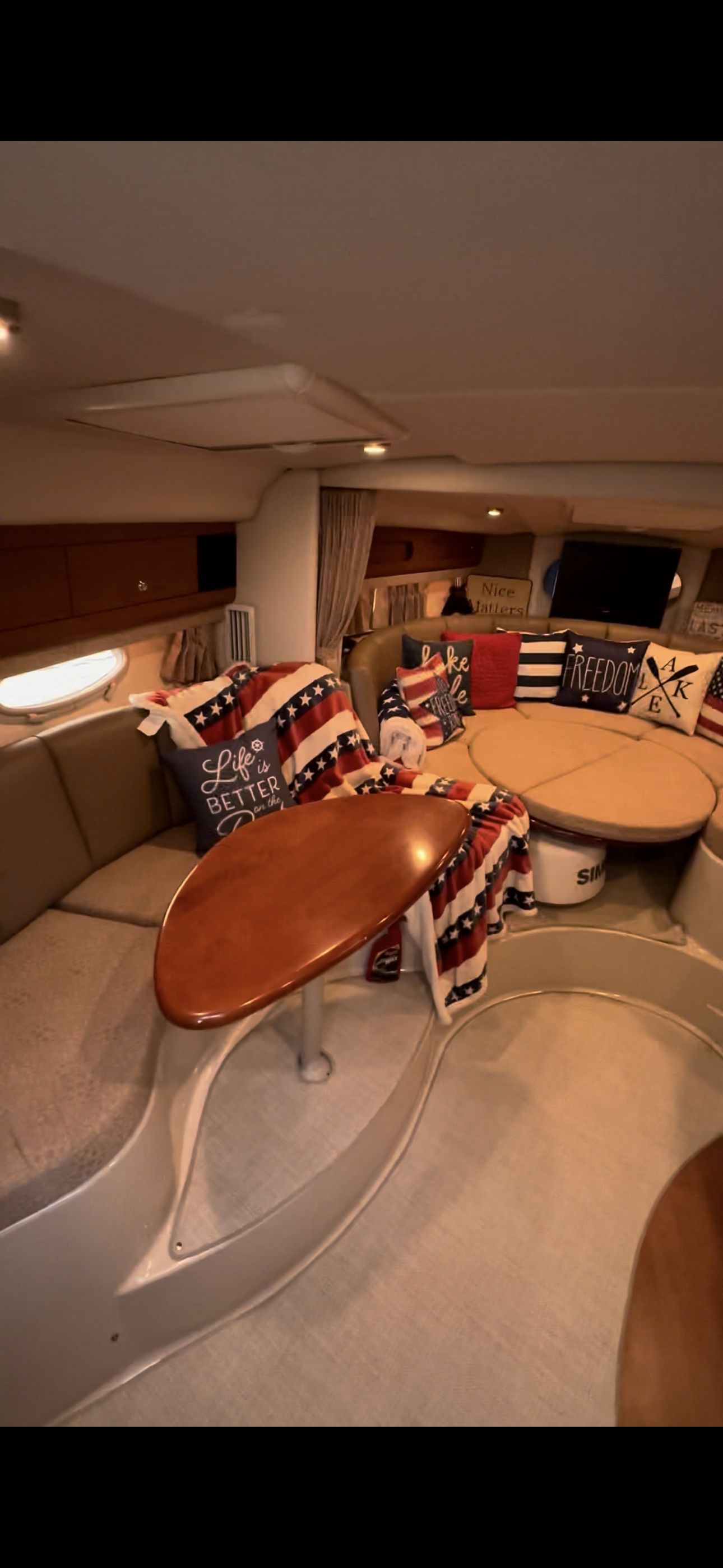 The interior of a 2004 Chaparral Signature 330 features a cozy seating area with cushions.