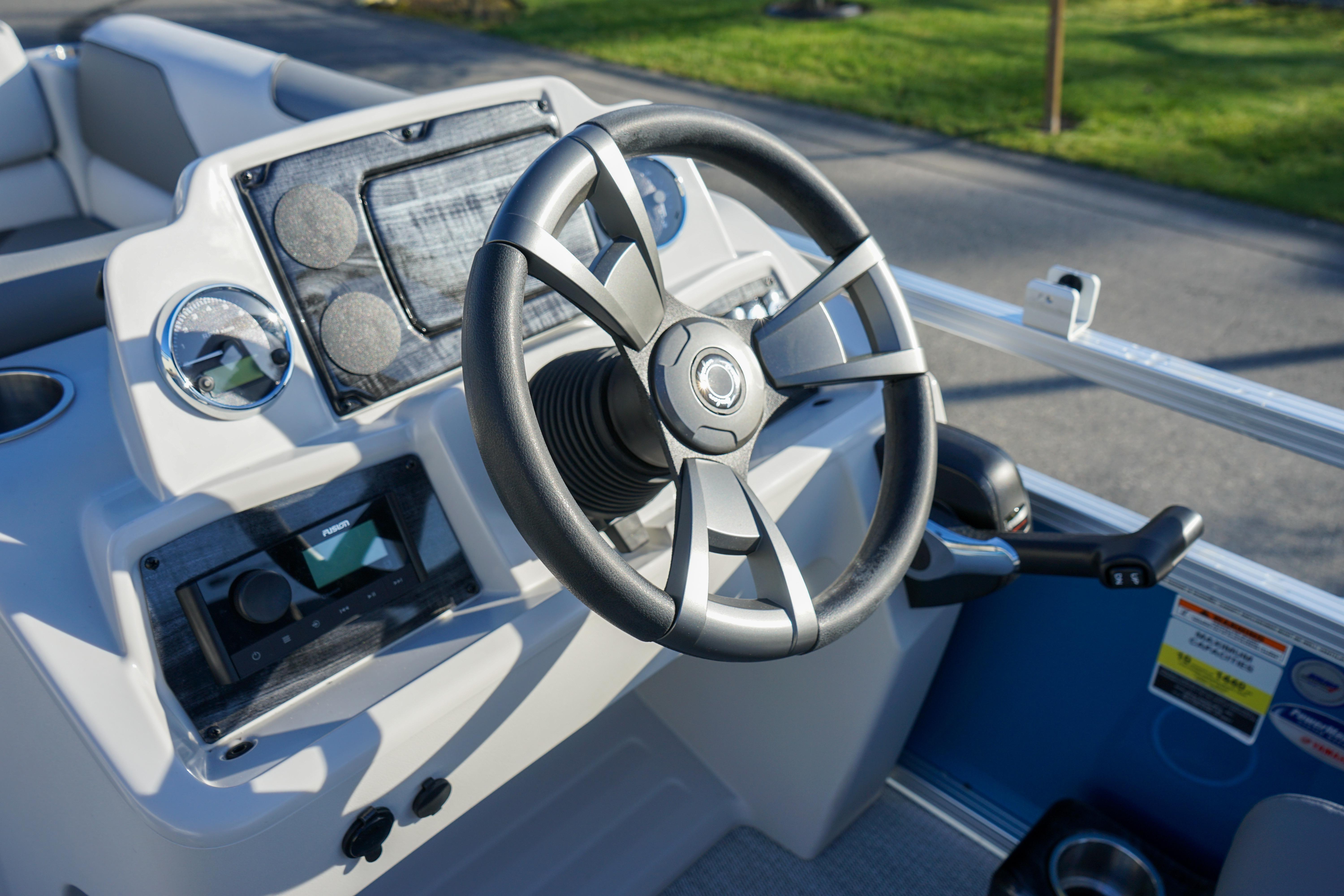 Steering console of 2024 Avalon 17 Venture Cruise boat, featuring modern controls and design.