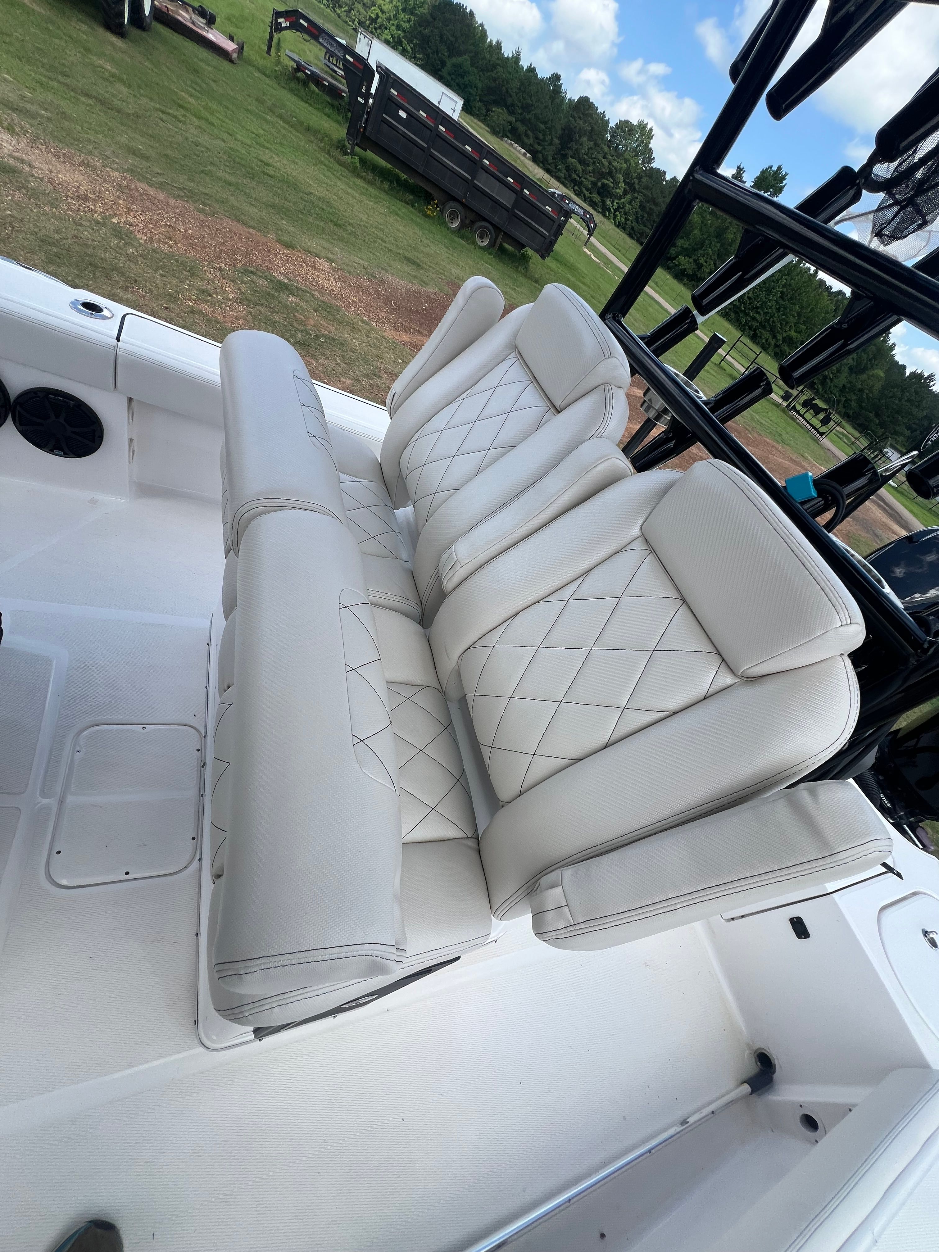 The 2023 Blue Wave 2800 Makaira features luxurious, cushioned seats with a quilted design.